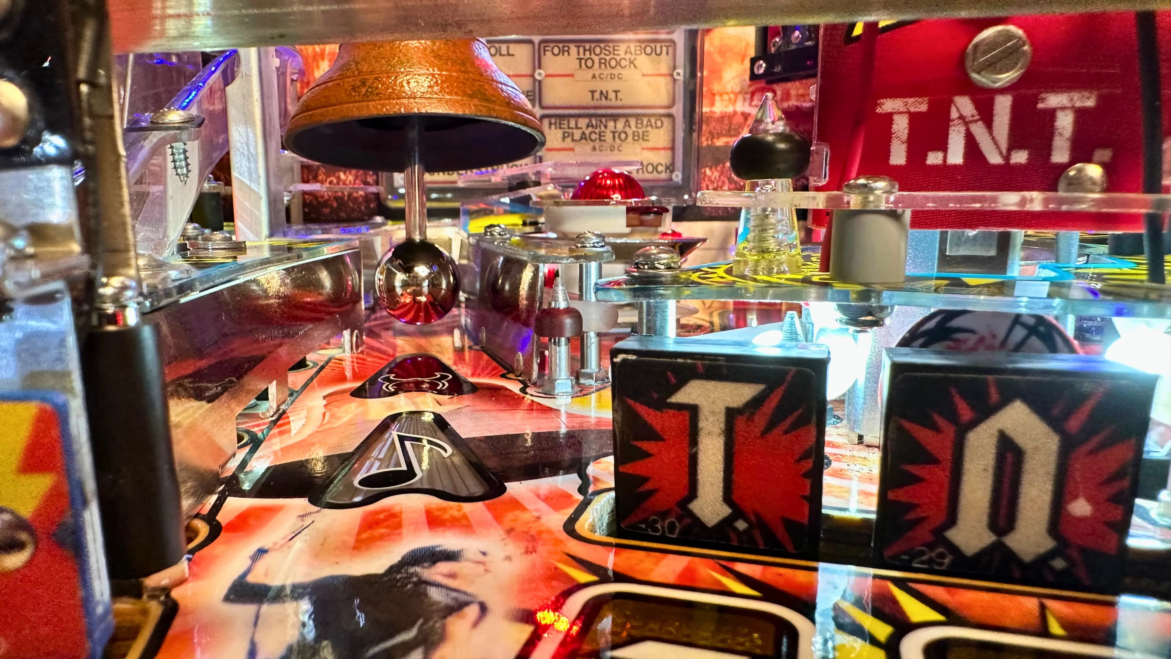 Vintage AC/DC pinball machine with TNT theme and colorful lights