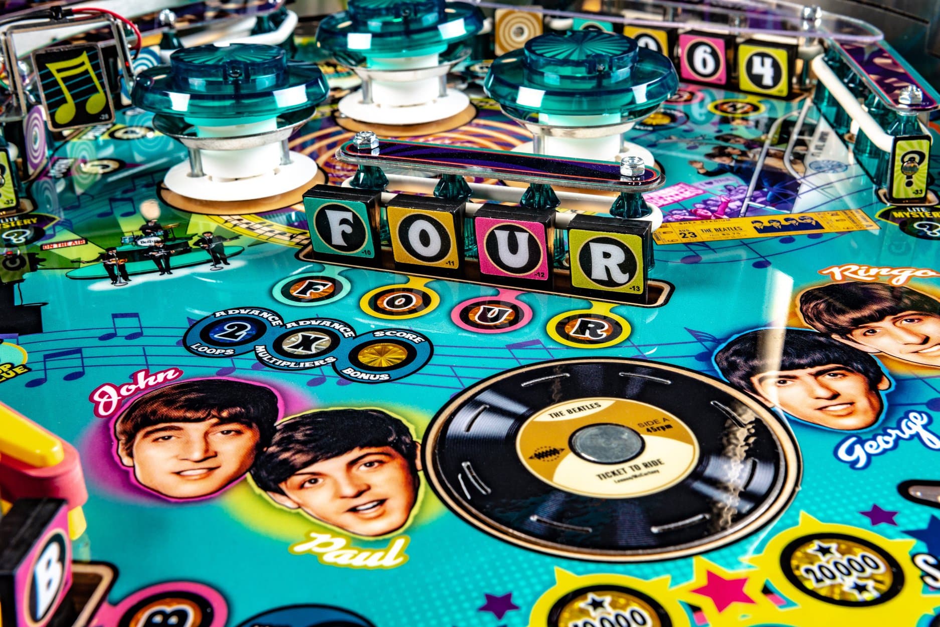The Beatles pinball machine with colorful board, records, and band images