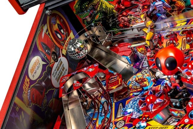 Colorful pinball machine with intricate details and silver ball in play