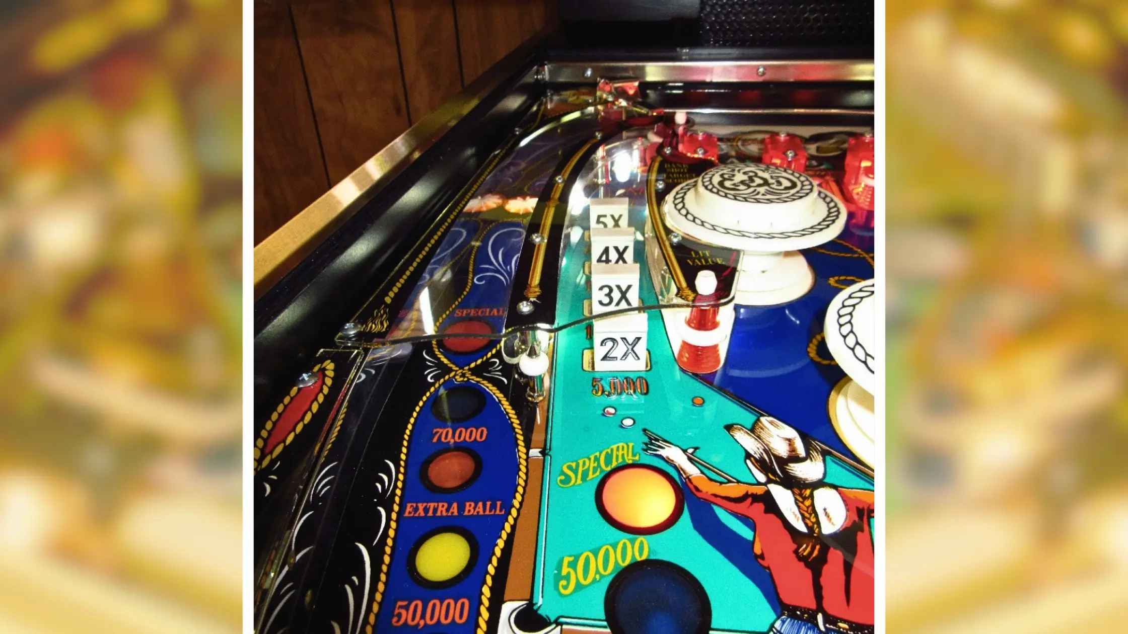 Colorful pinball machine playfield with scoring lights and numbered targets