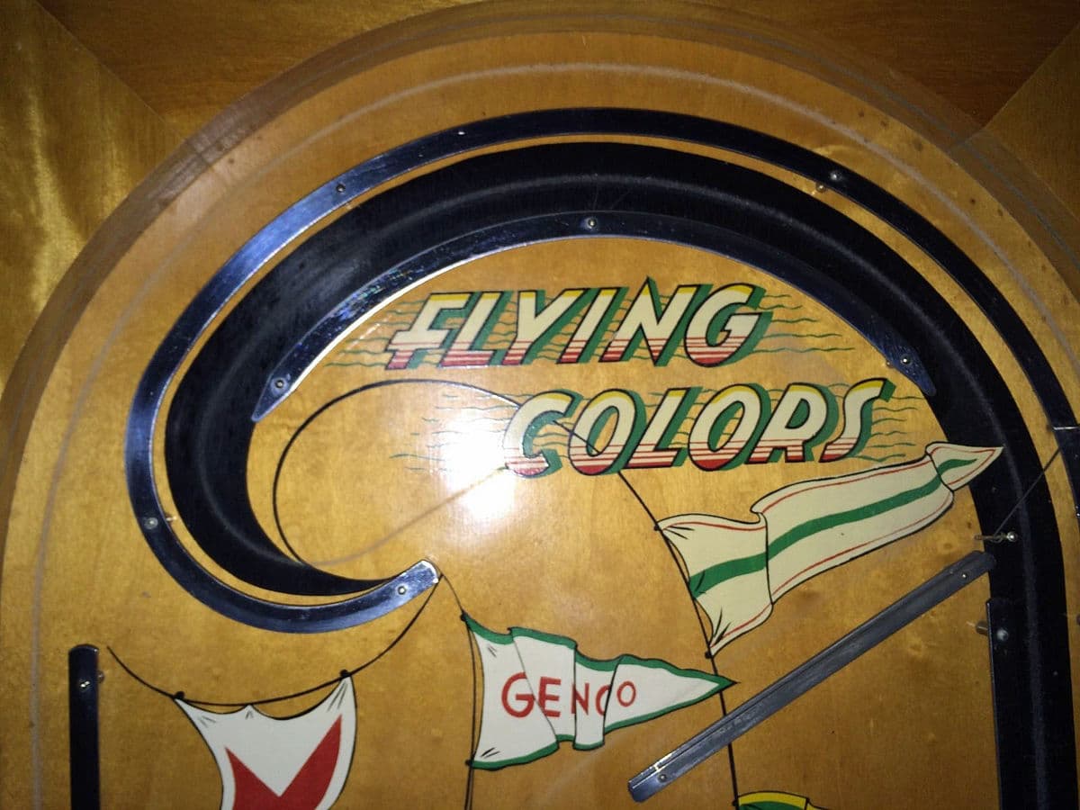 Vintage "Flying Colors" poster with colorful flags and curved design