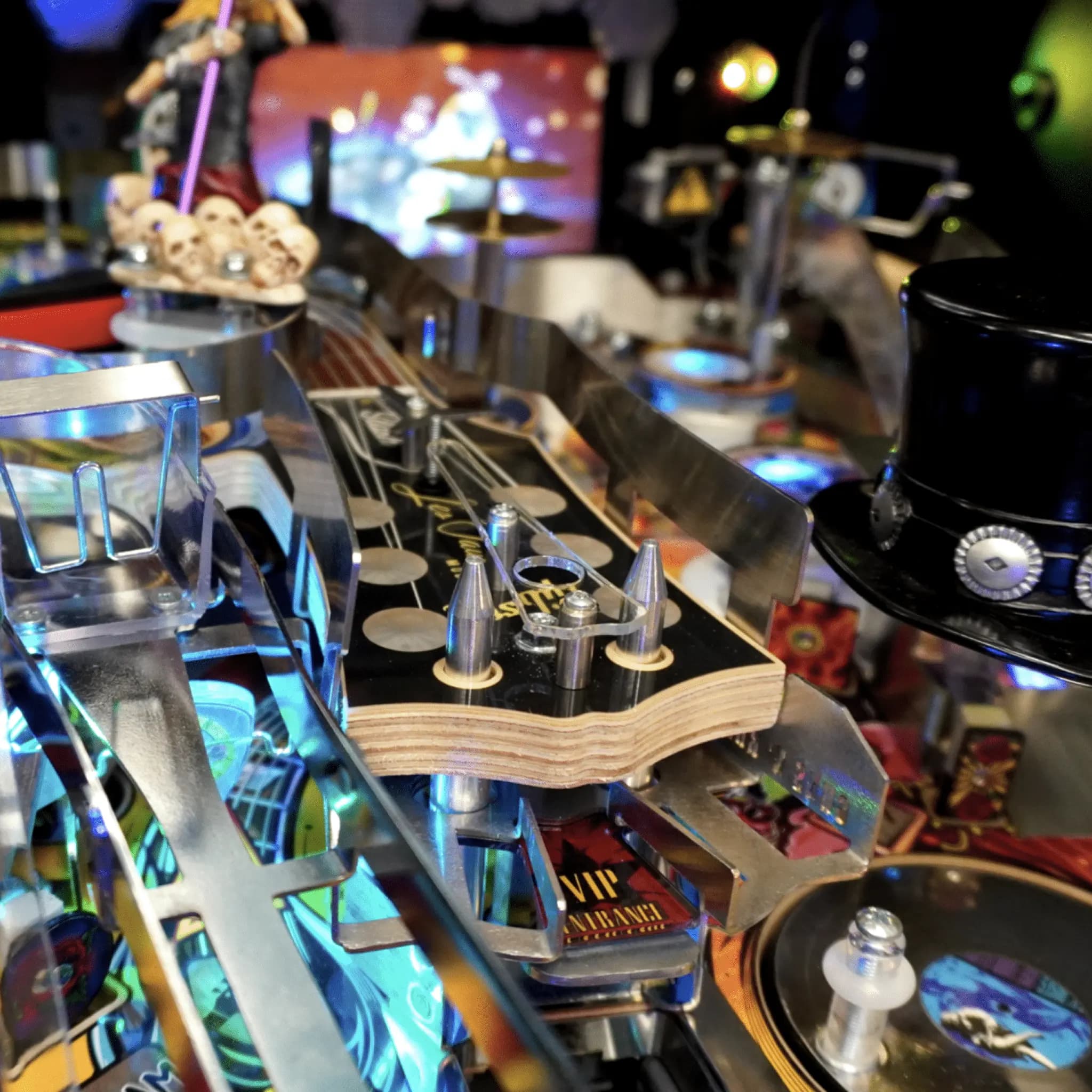Detailed close-up of a pinball machine with colorful lights and metallic components