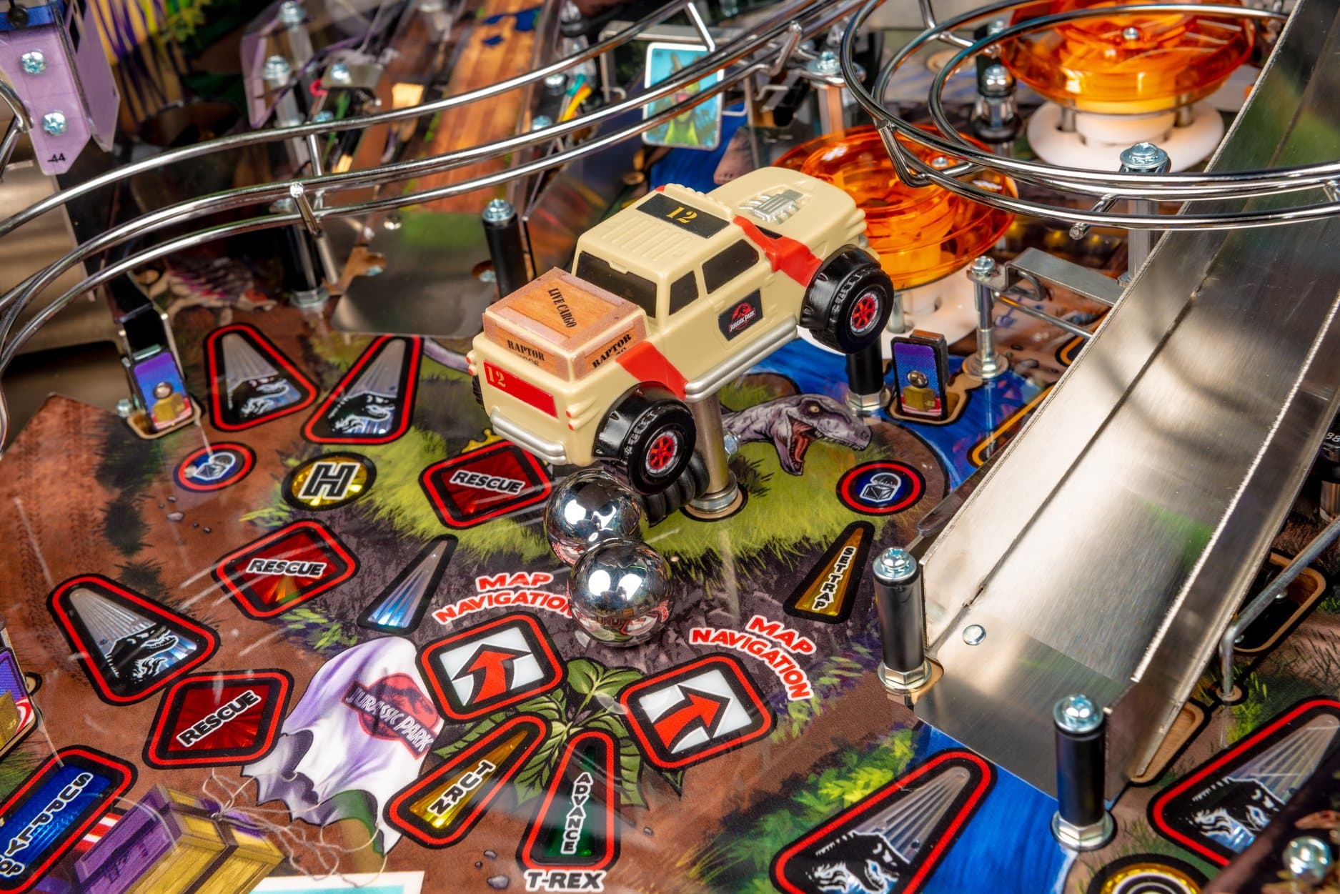 Jurassic Park pinball machine closeup with rescue vehicle and chrome balls