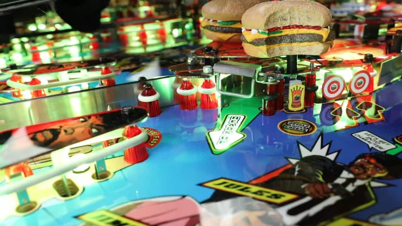 Colorful pinball machine with burger and Christmas-themed elements
