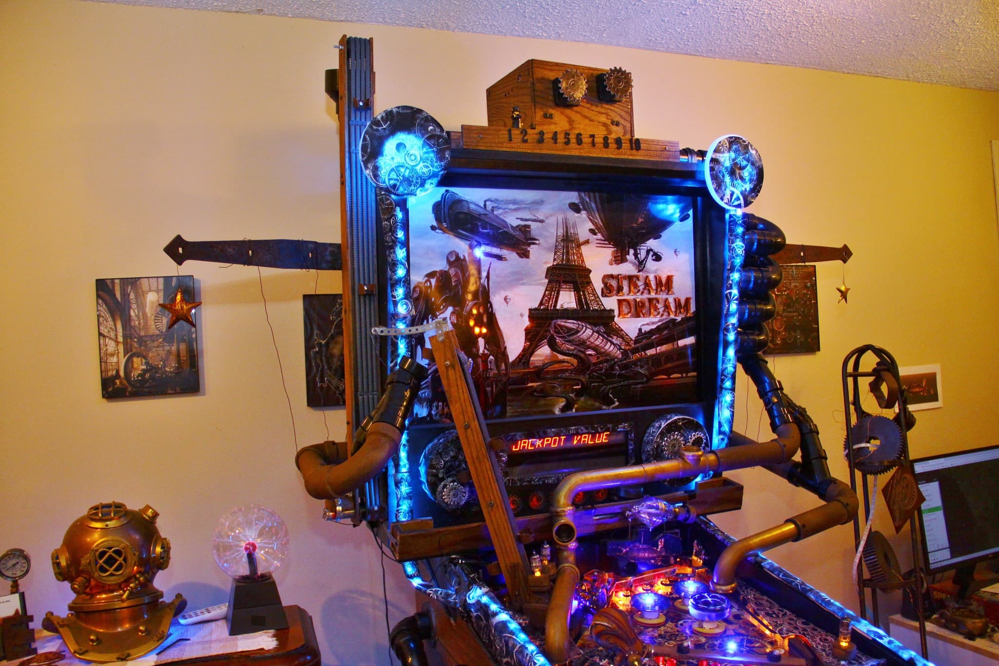 Steampunk-themed pinball machine with blue lights and Eiffel Tower backdrop