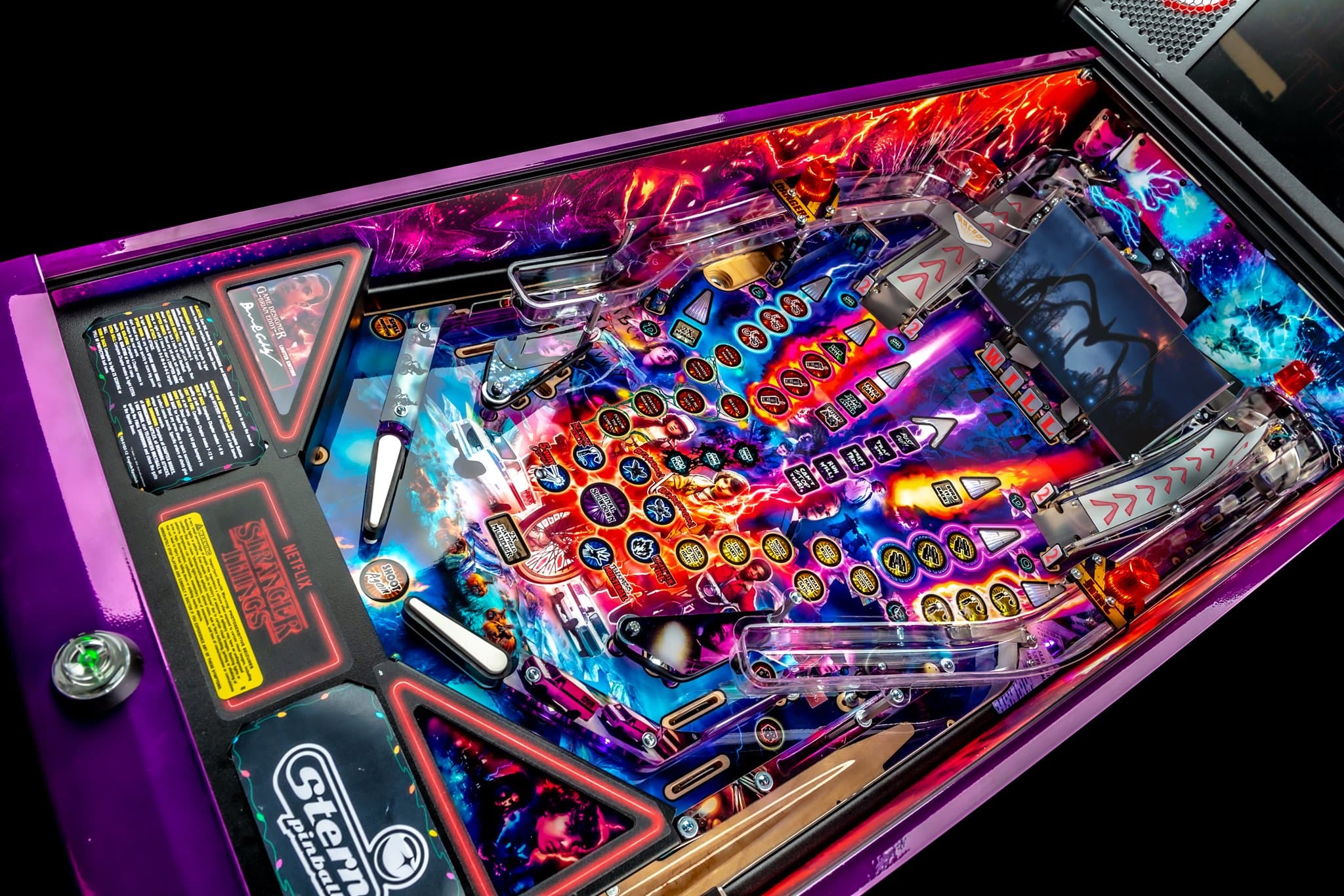 Colorful Stranger Things pinball machine with vibrant playfield and flippers