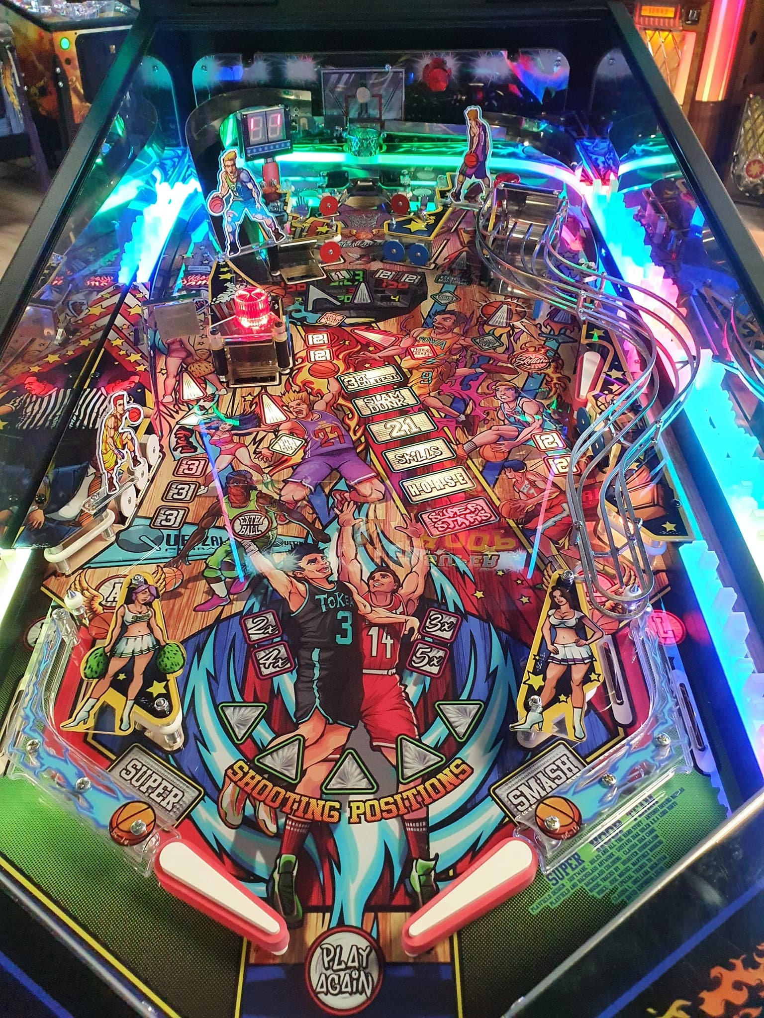 Colorful basketball-themed pinball machine with vibrant neon lights and players