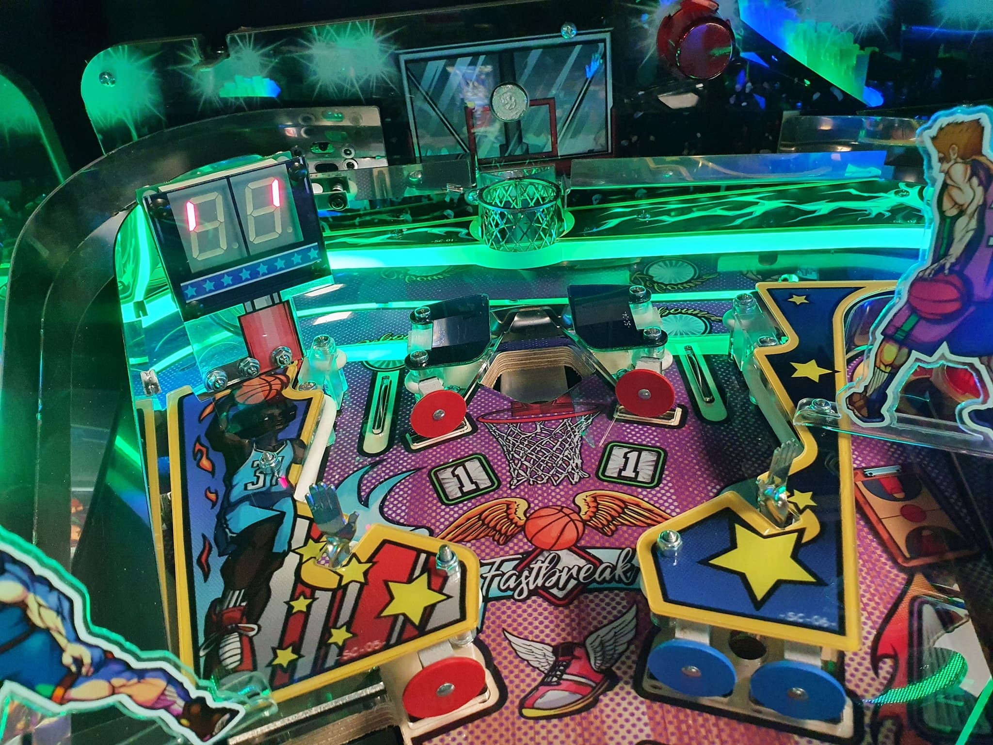 Colorful basketball-themed pinball machine with neon green lighting