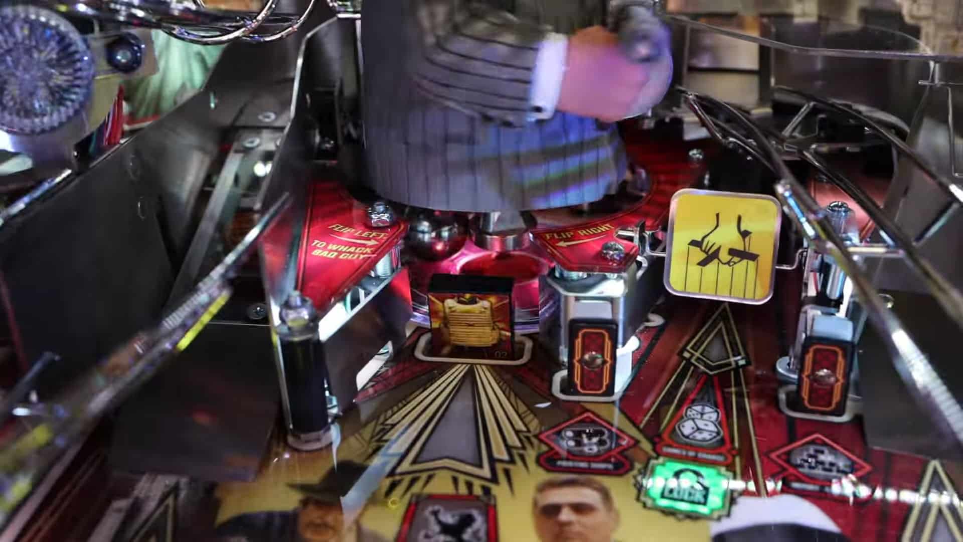 Colorful pinball machine with red, yellow, and green playfield details