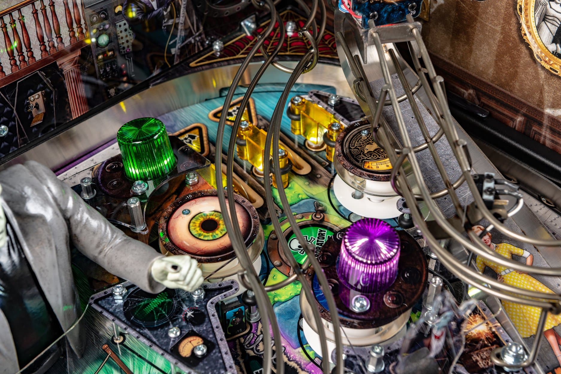 Intricate pinball machine interior with colorful lights and mechanical components