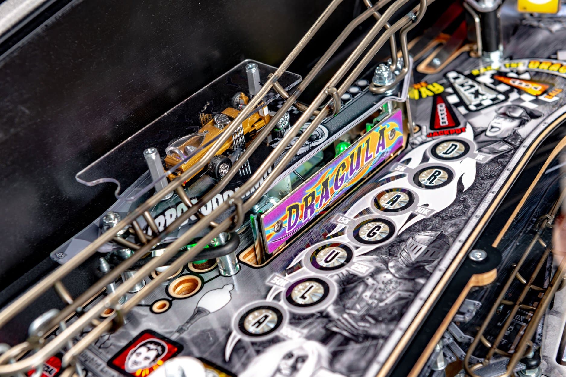 Detailed view of a pinball machine with colorful graphics and mechanical components