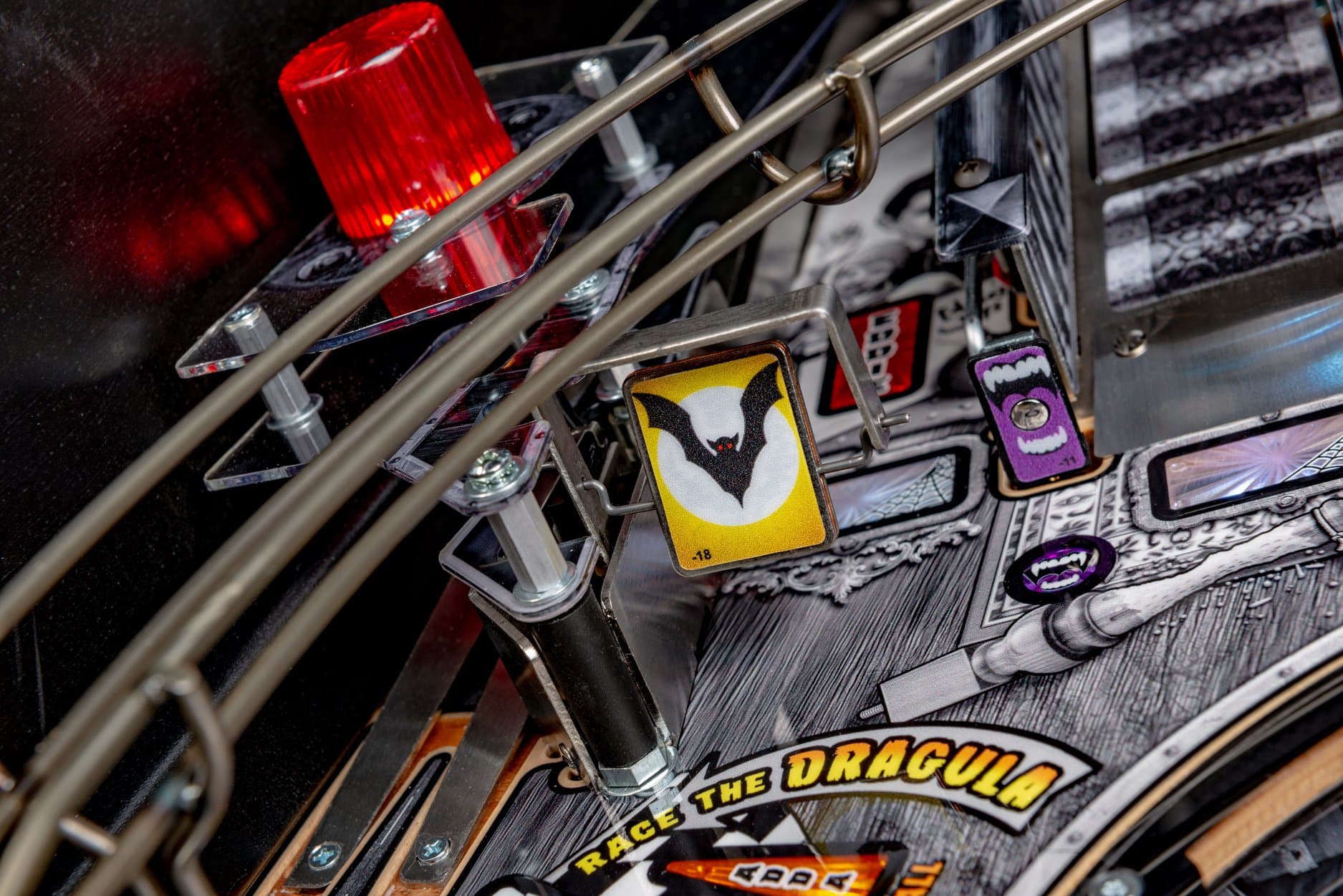 Pinball machine detail with Dracula theme, red warning light, and bat icon