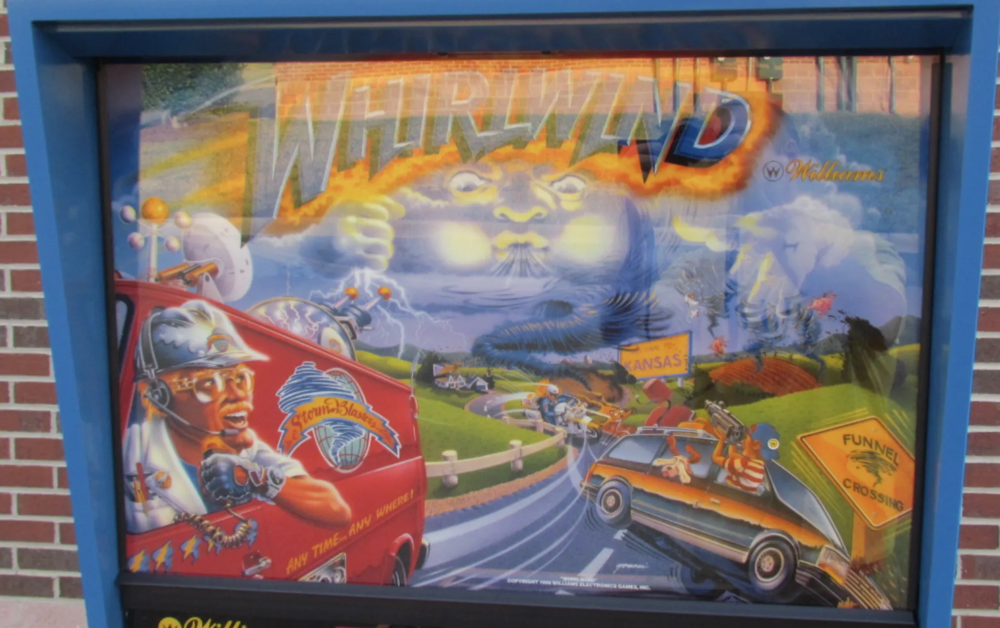 Whirlwind pinball machine artwork with racing cars and mystical sky
