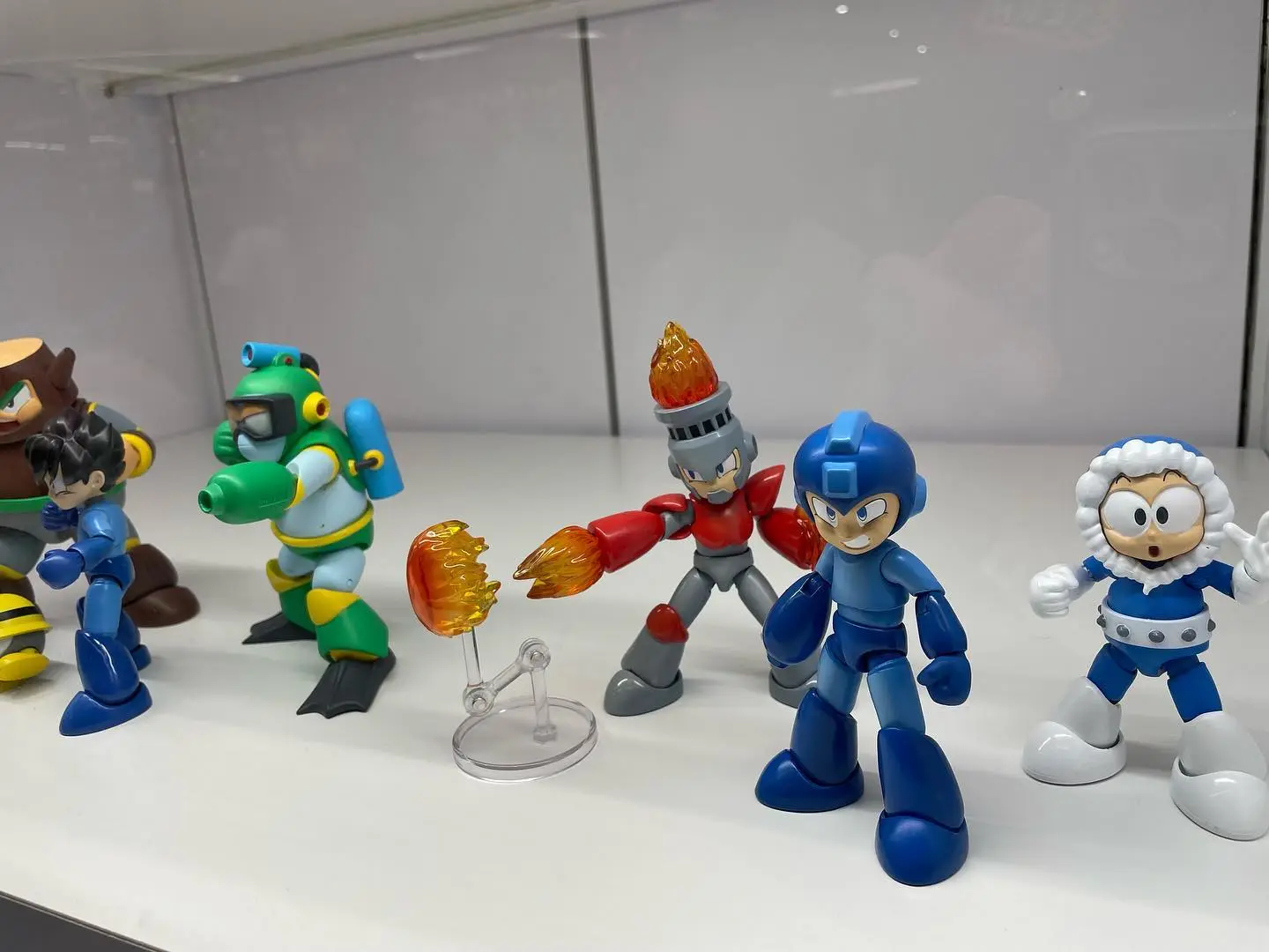 Mega Man action figures with various characters on display shelf