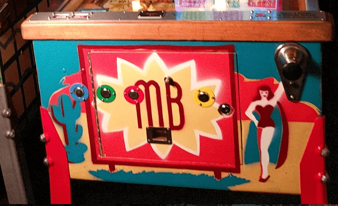 Vintage pinball machine with colorful MB logo and retro design elements