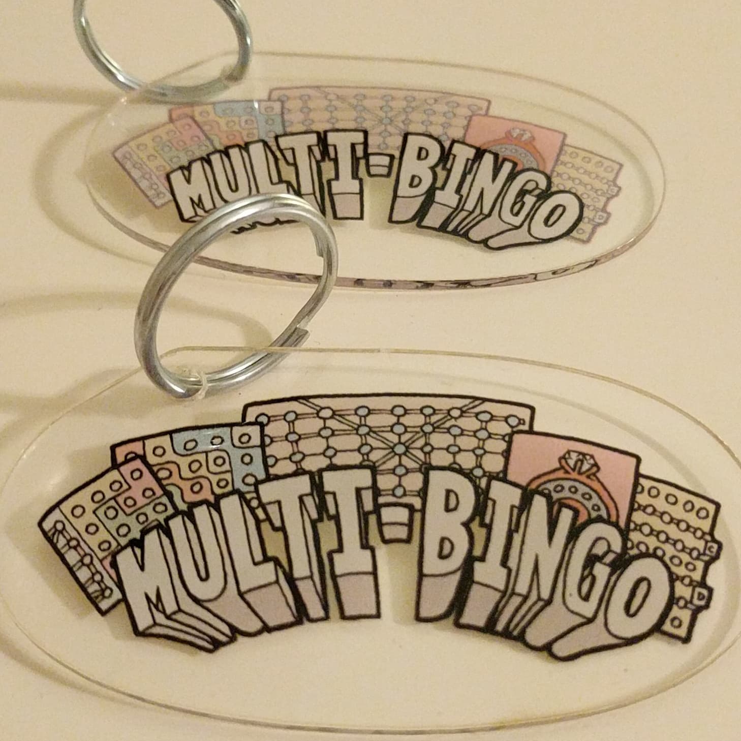Multi-Bingo logo with game cards and metal rings on light background