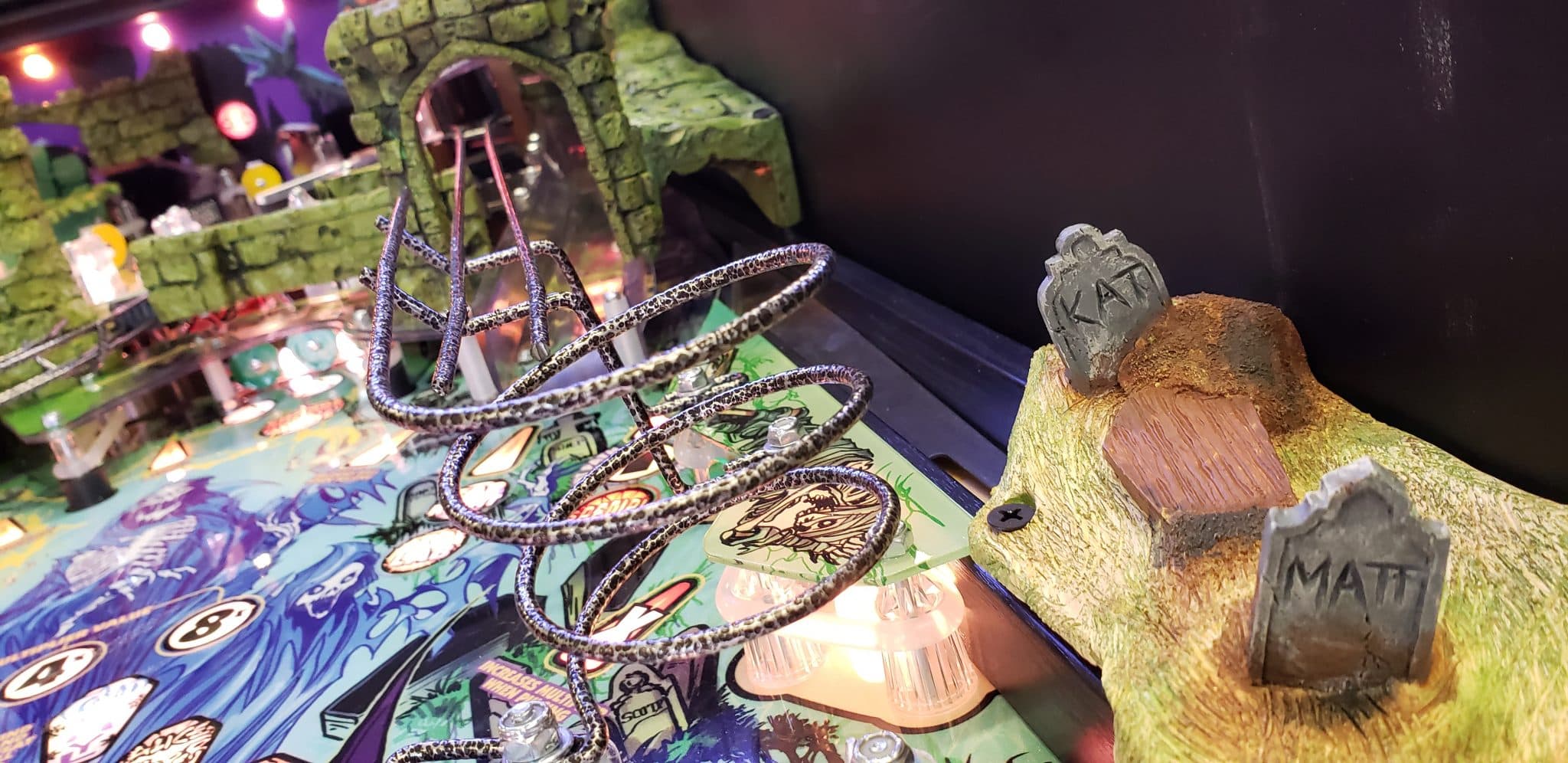 Spooky board game with wire spider decoration and miniature tombstones