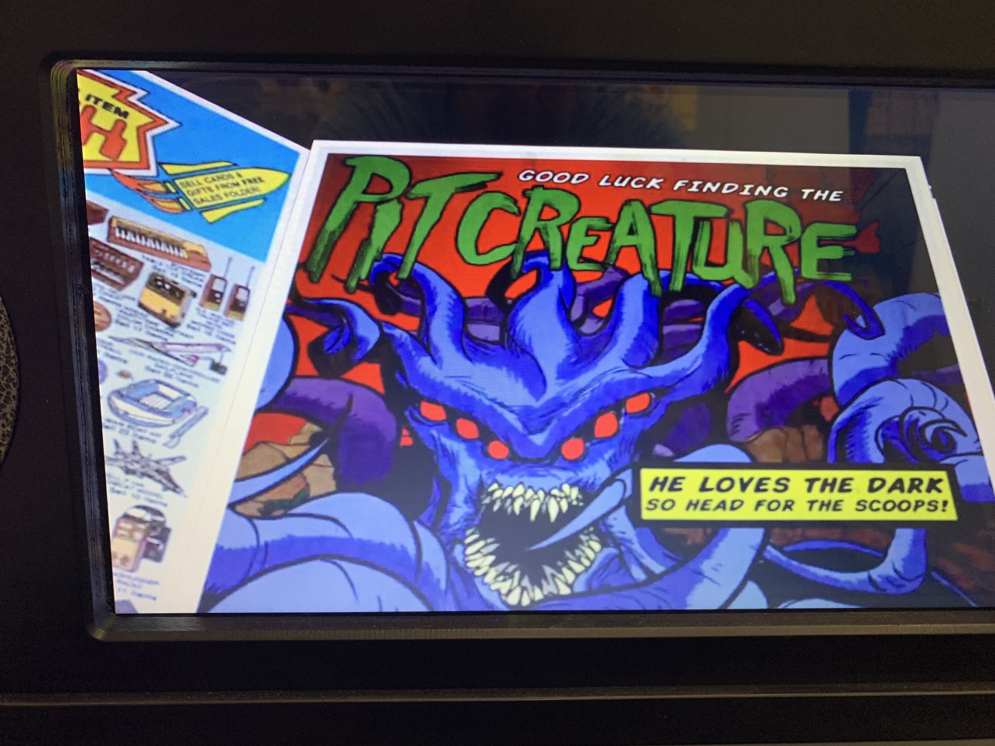 Vintage comic book poster of blue monster creature with sharp teeth