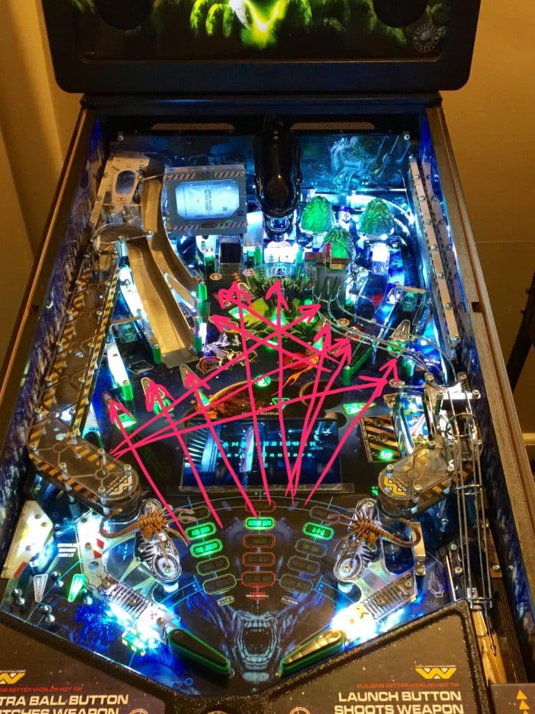 Aliens-themed pinball machine with glowing blue and green lights