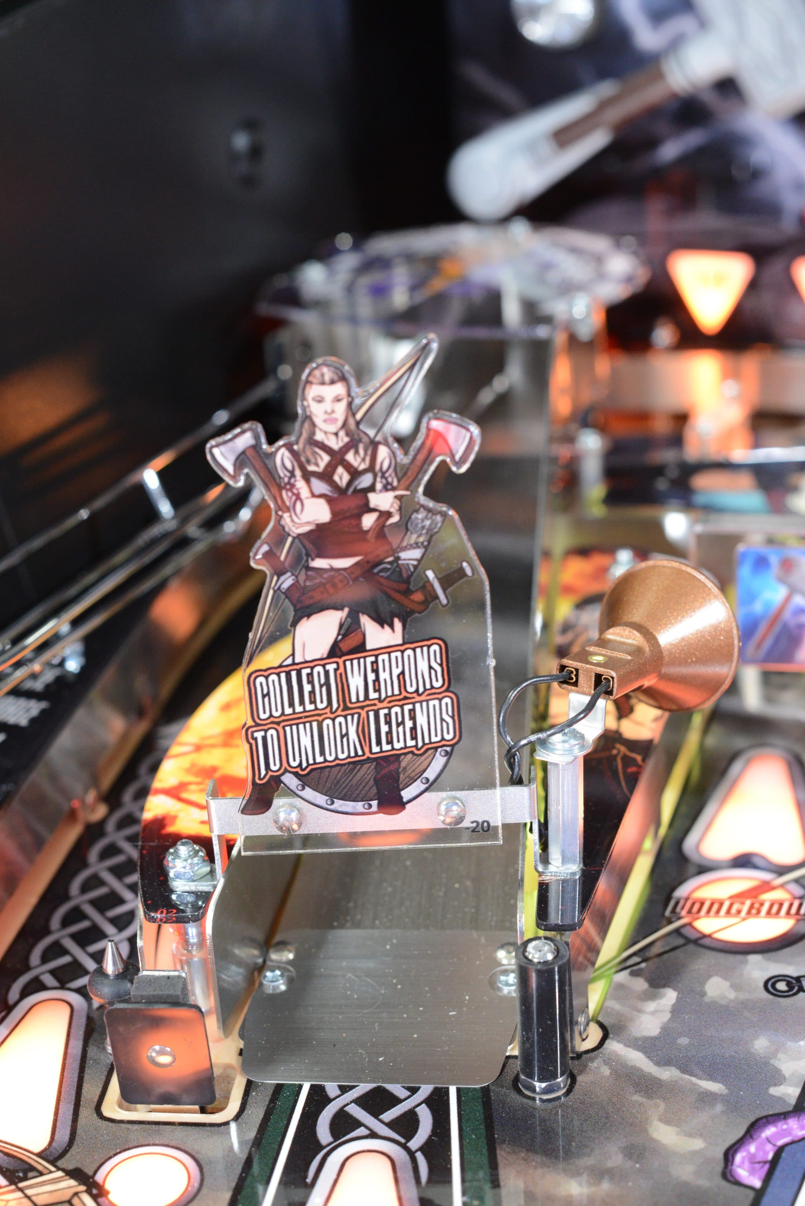 Game figure on stand with "Collect Weapons to Unlock Legends" text