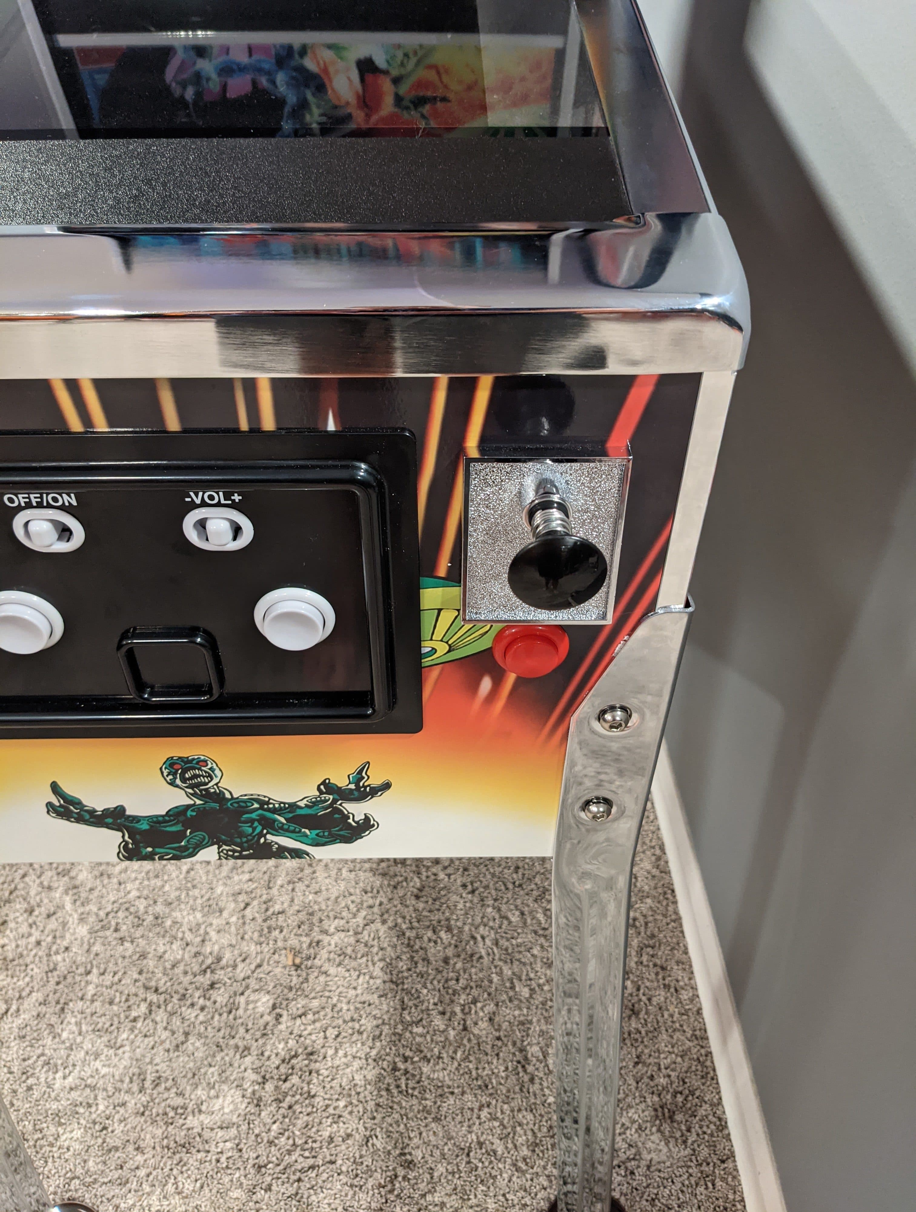 Vintage arcade machine with monster graphic and control panel
