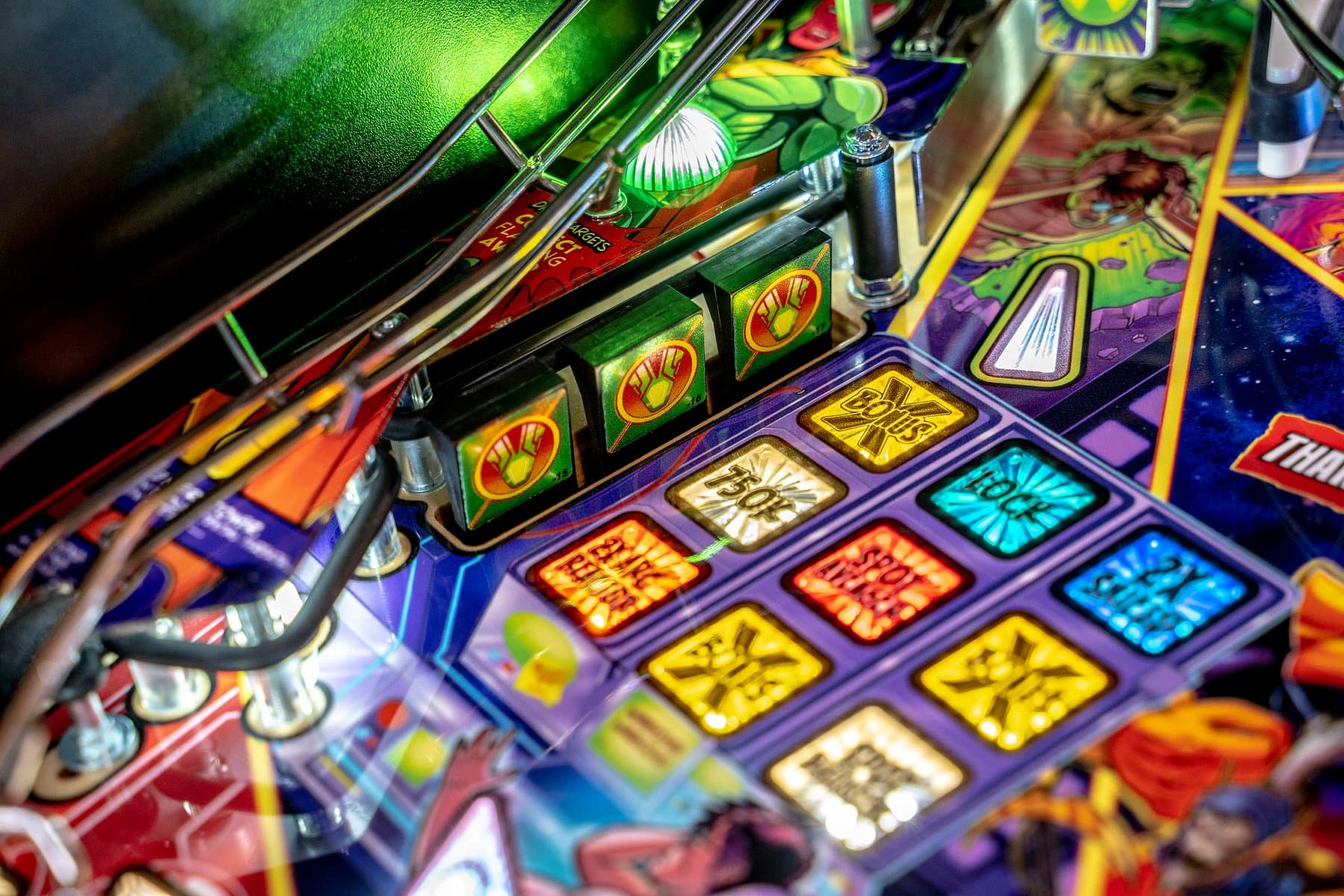 Colorful pinball machine dashboard with illuminated buttons and indicators