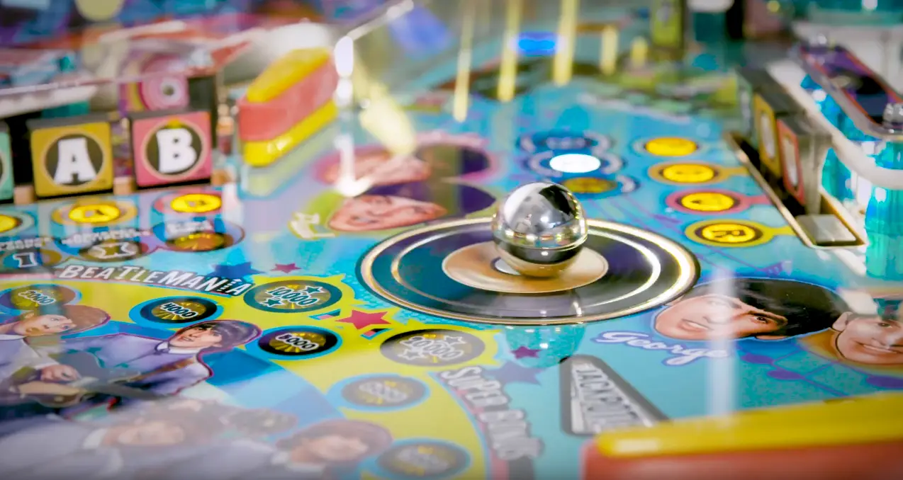 Colorful board game with metal ball, letter blocks, and circular game spaces