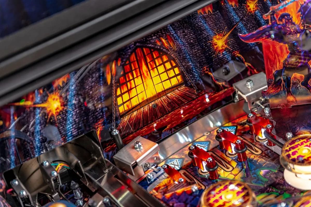 Colorful pinball machine with fiery medieval castle and explosive graphics