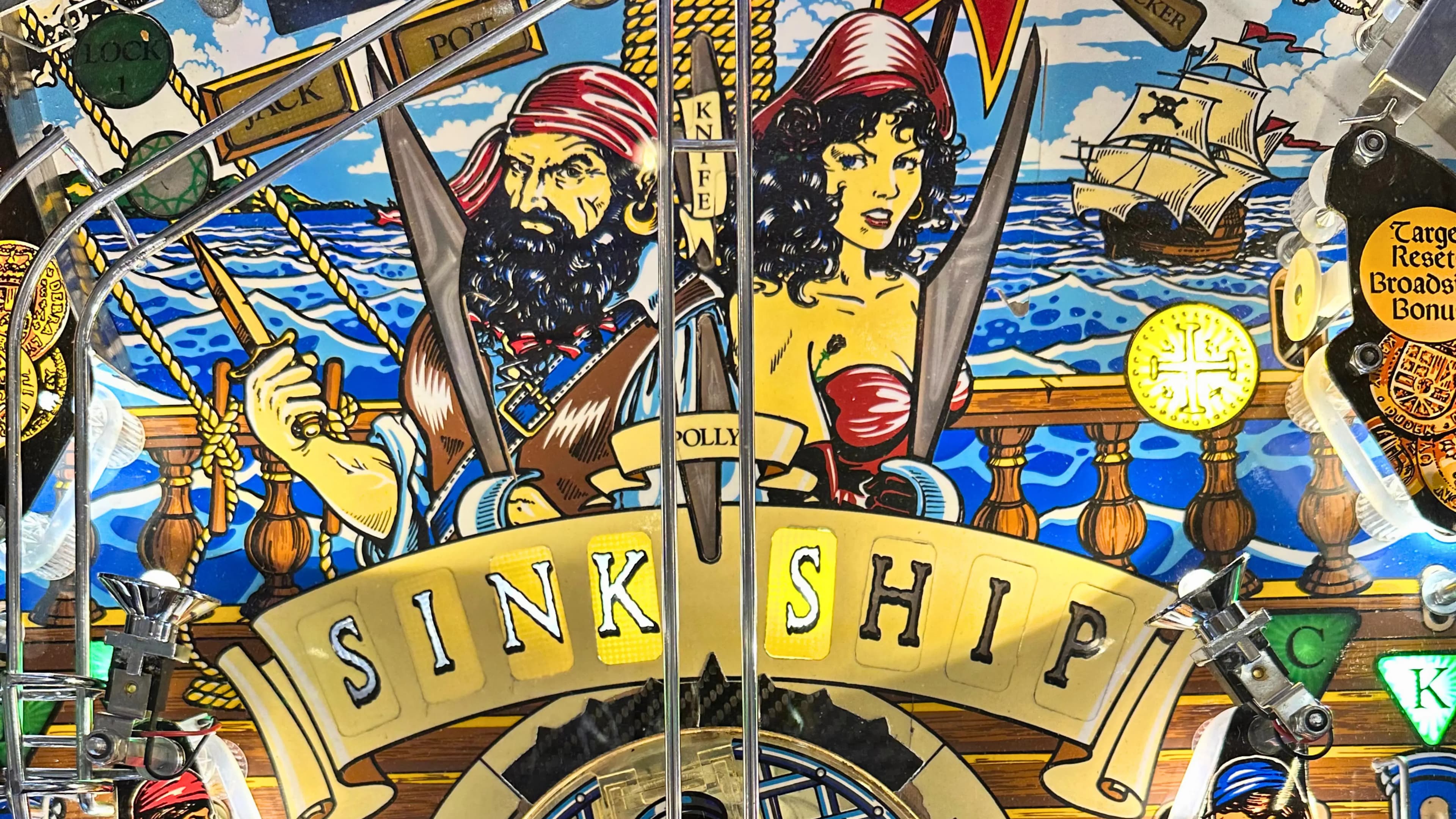 Colorful pinball machine backglass with pirates and nautical theme