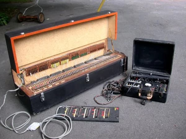 Vintage electronic equipment with circuit boards and cases on concrete surface