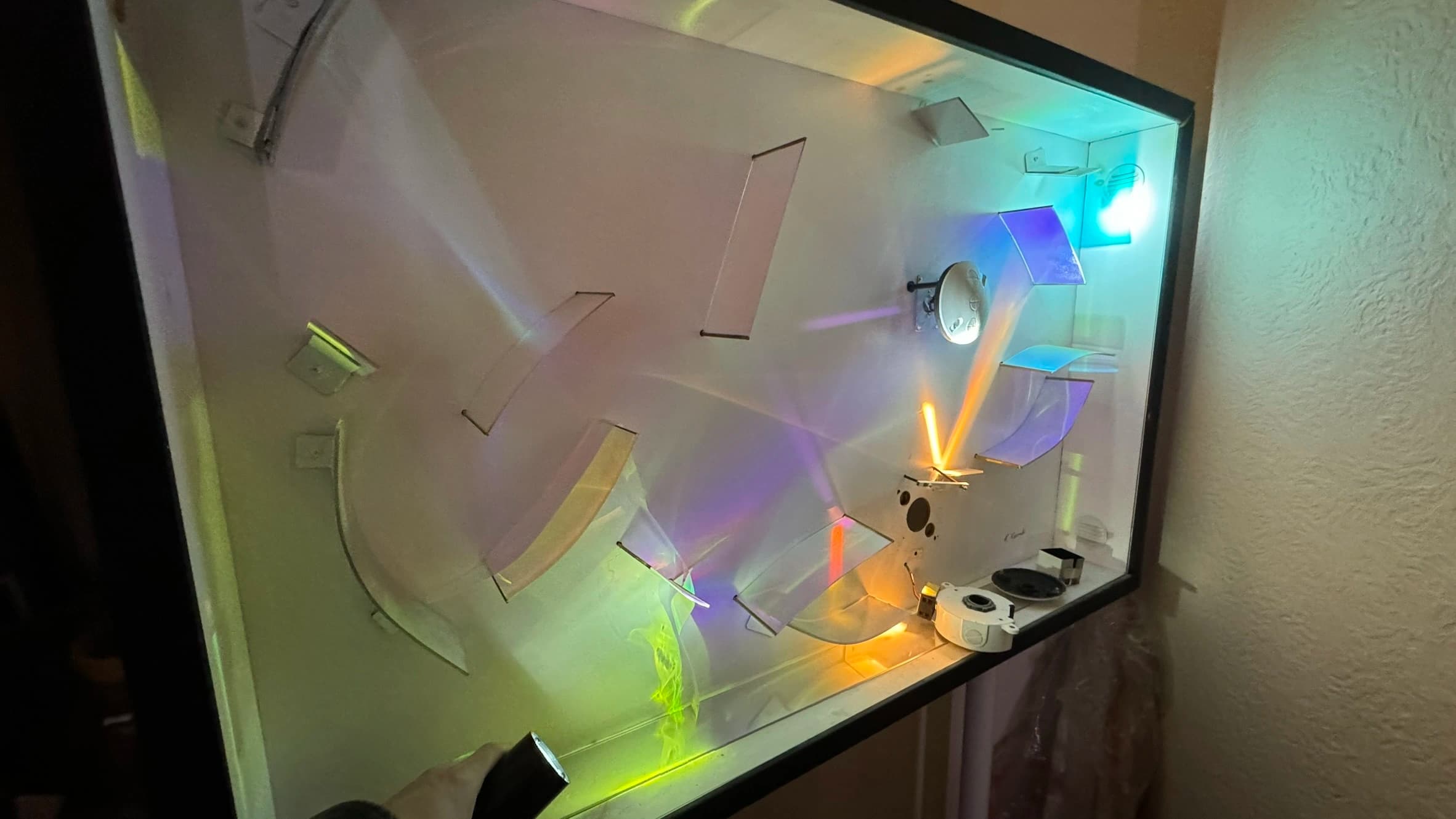 Scientific experiment with colorful light refractions in enclosed glass chamber