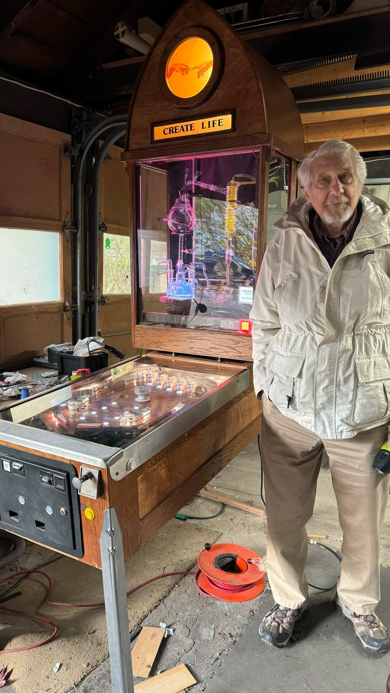 Create Life machine with glowing scientific apparatus and elderly inventor nearby