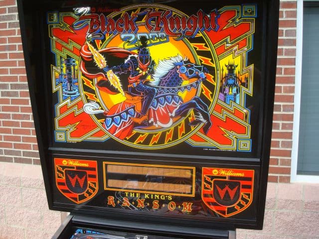 Vintage Black Knight pinball machine backglass with colorful medieval knight