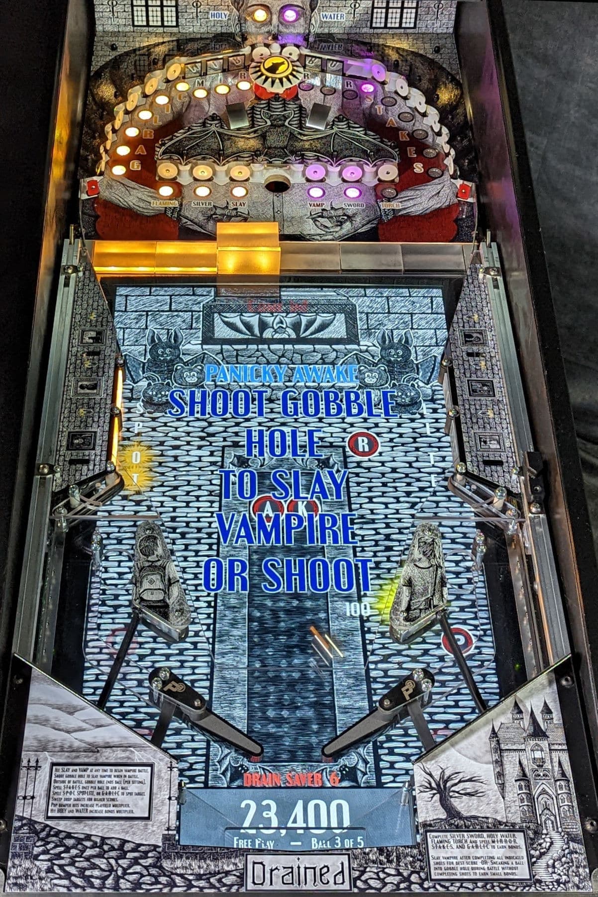 Vampire-themed pinball machine with glowing lights and gothic design