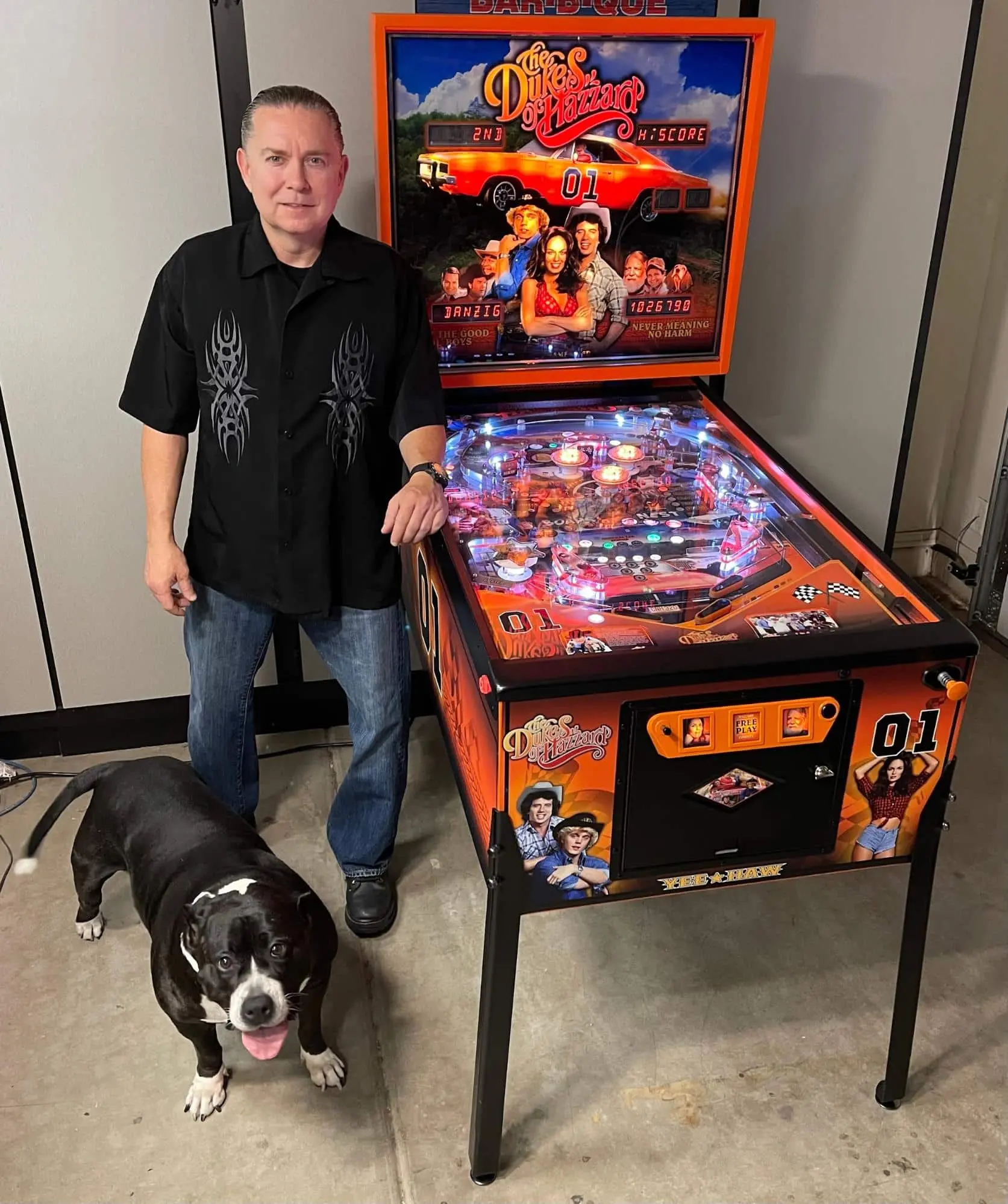 Dukes of Hazzard pinball machine with man and black and white dog
