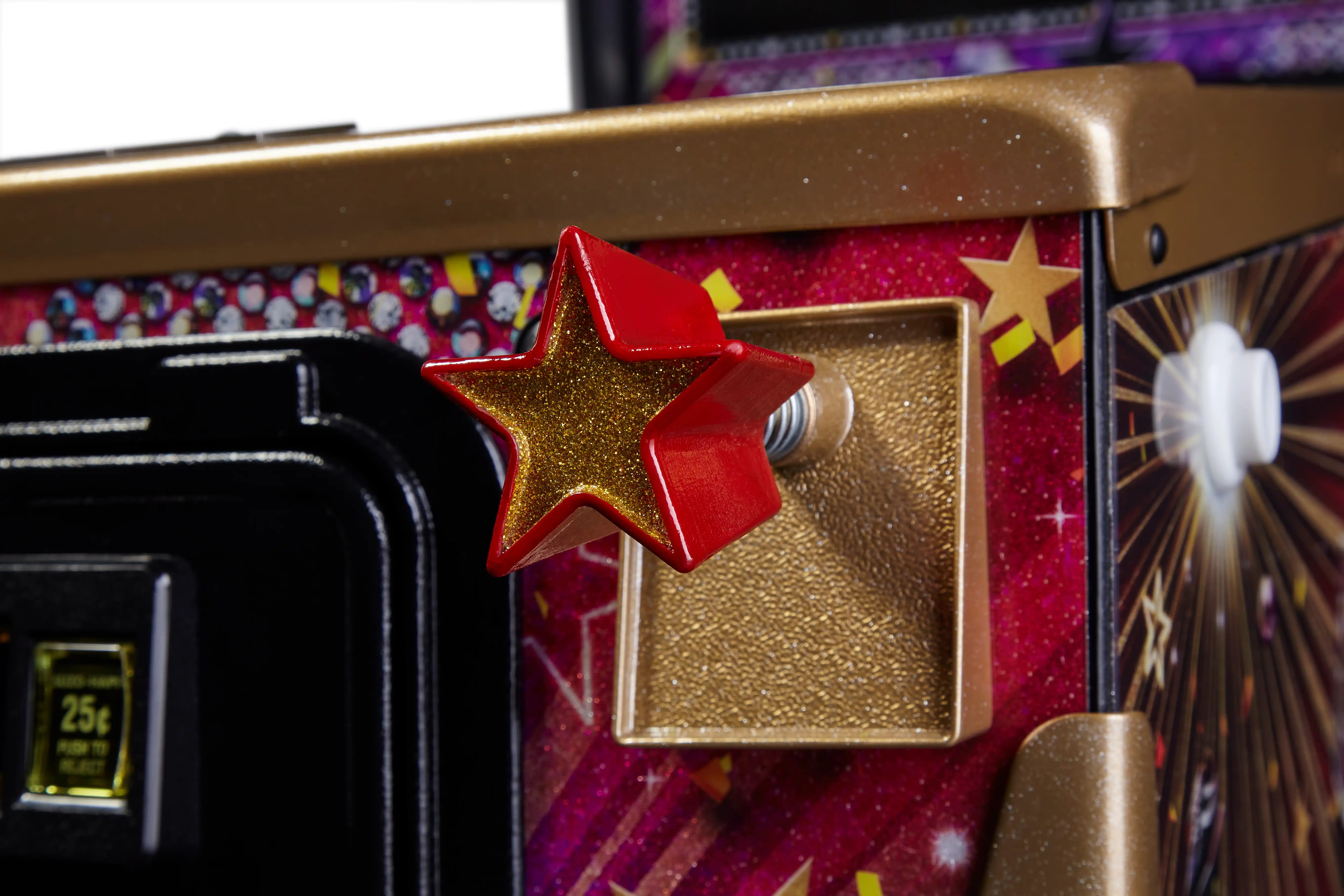 Glittery red and gold star on colorful arcade machine close-up