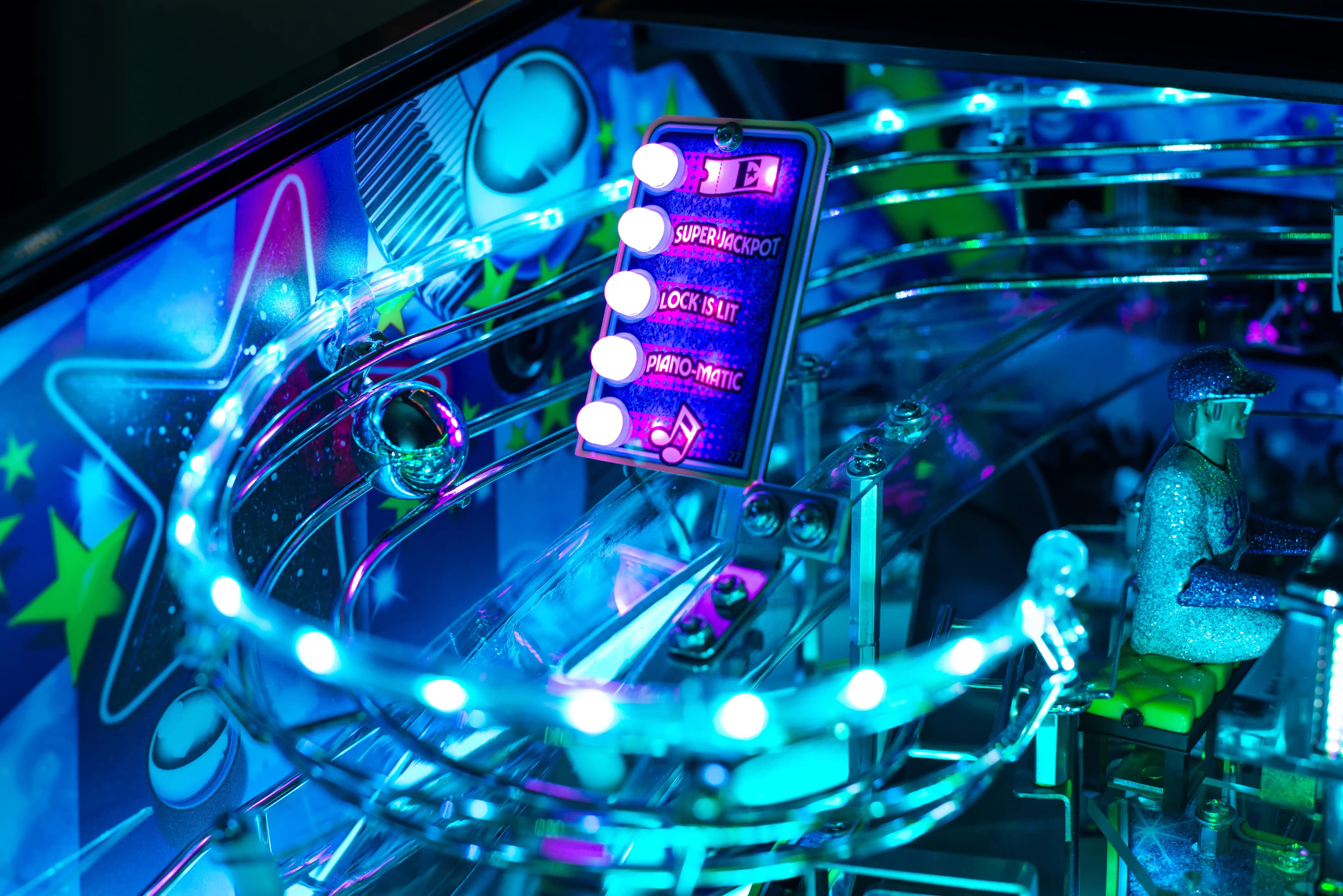 Colorful pinball machine with glowing blue and purple electronic display