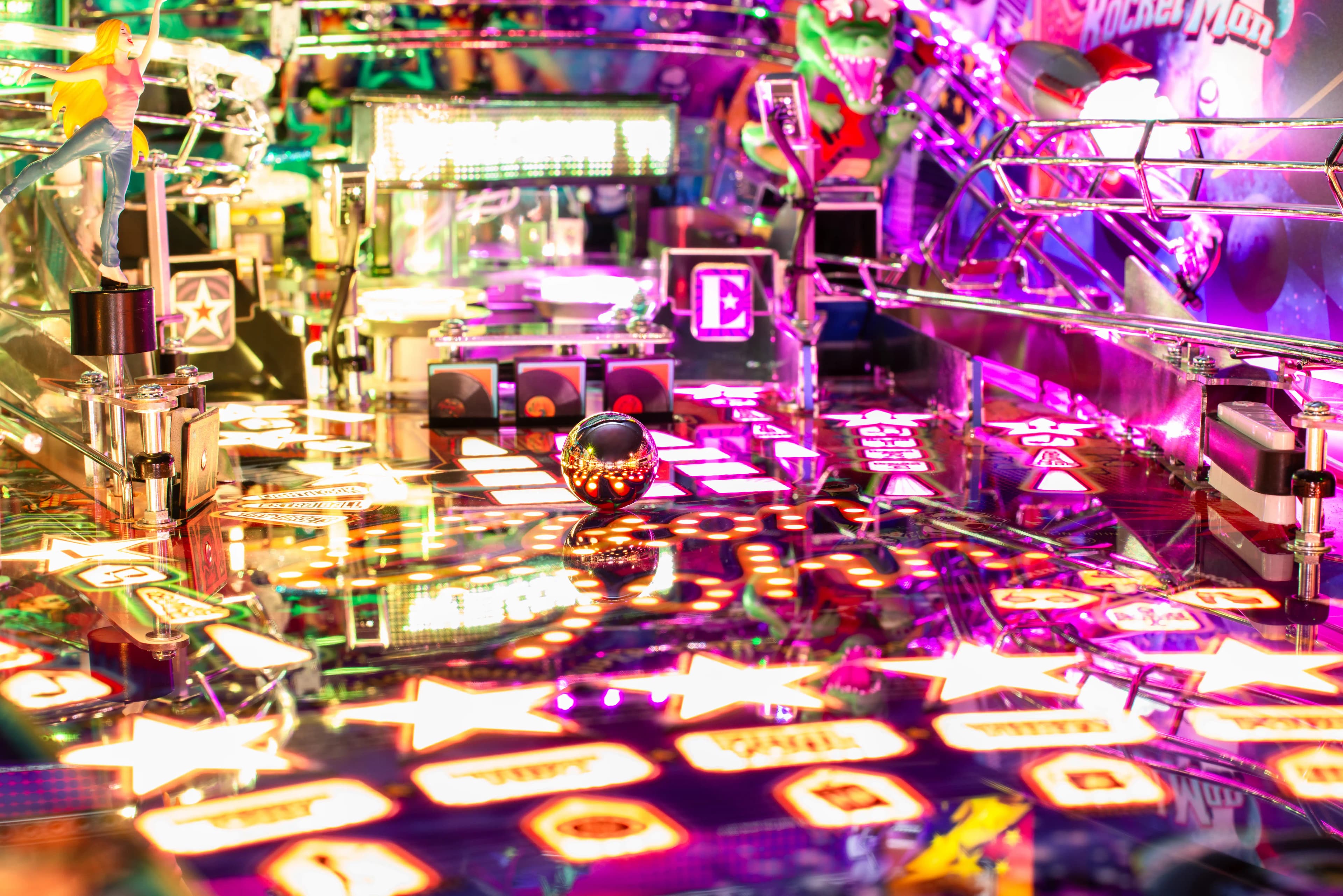 Colorful pinball machine with shiny ball and vibrant neon lights