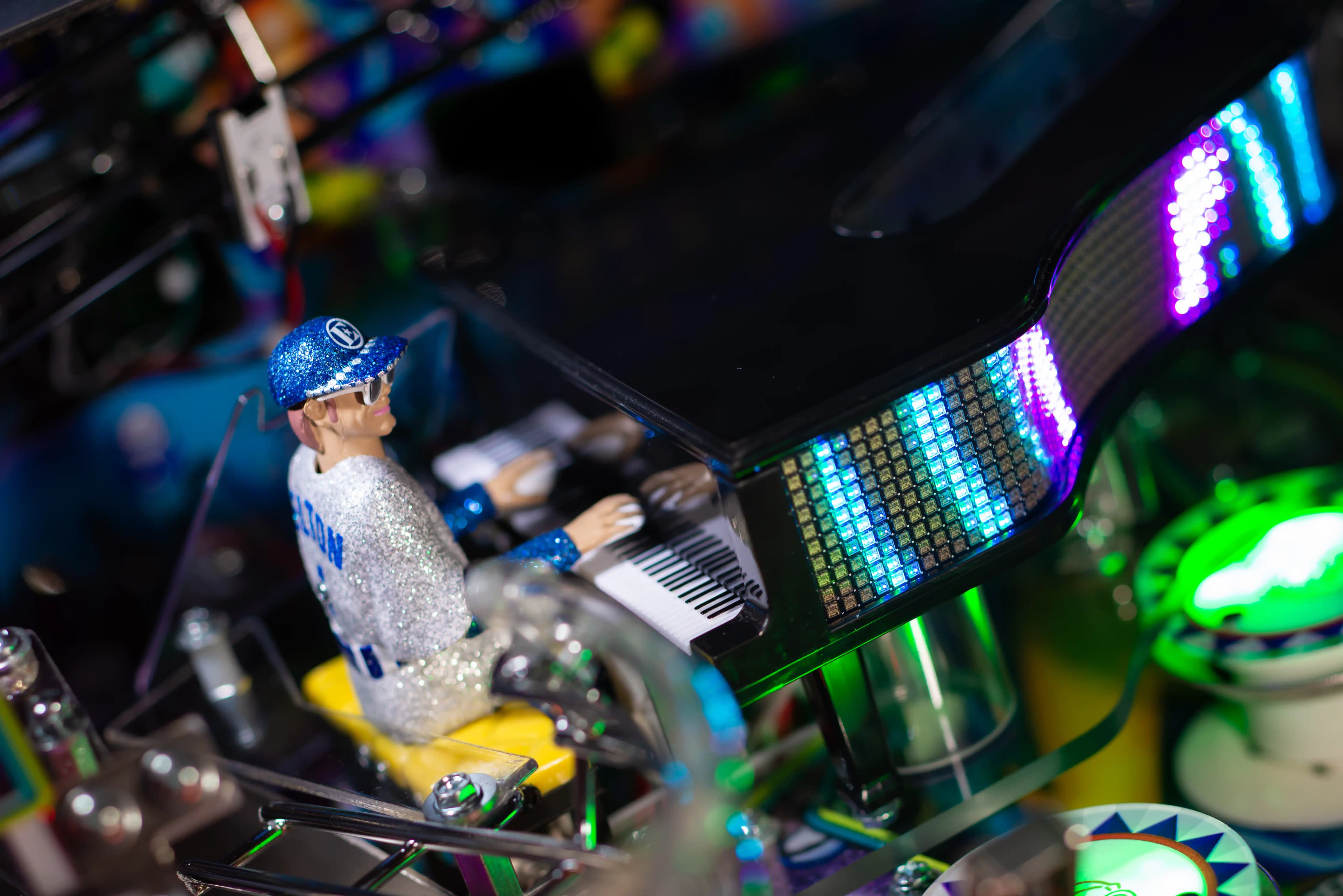 Glittery figure with keyboard and colorful LED display in complex setup