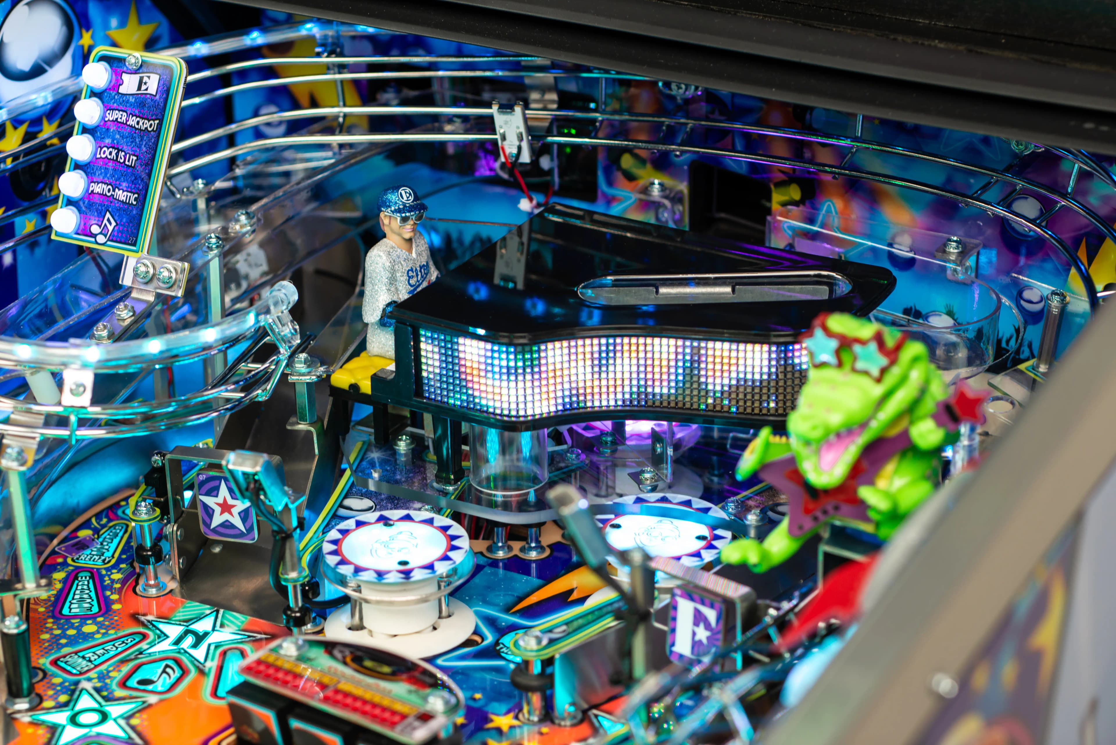Colorful pinball machine with detailed electronic display and figurine