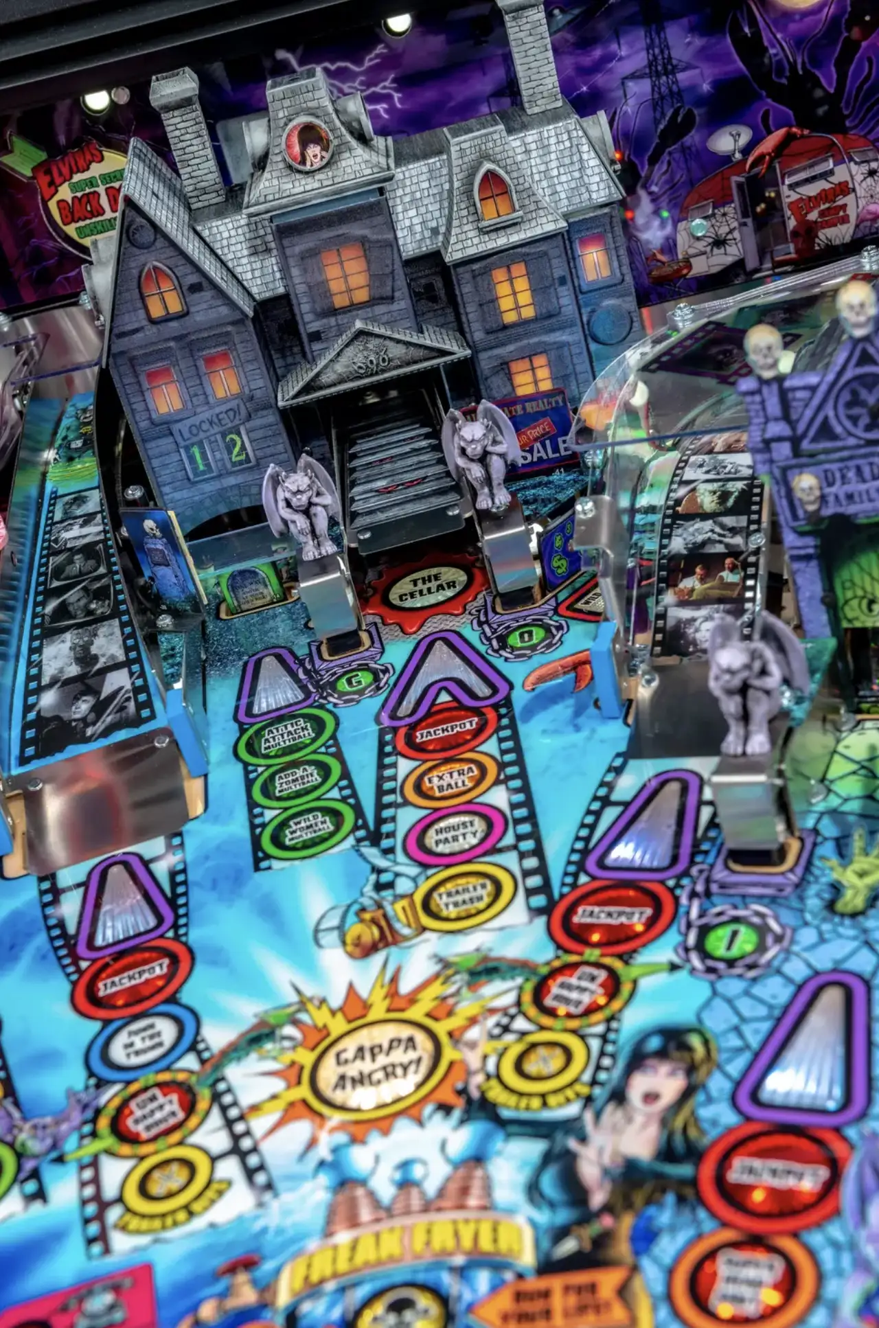 Haunted house pinball machine with colorful filmstrip-like scoring lanes