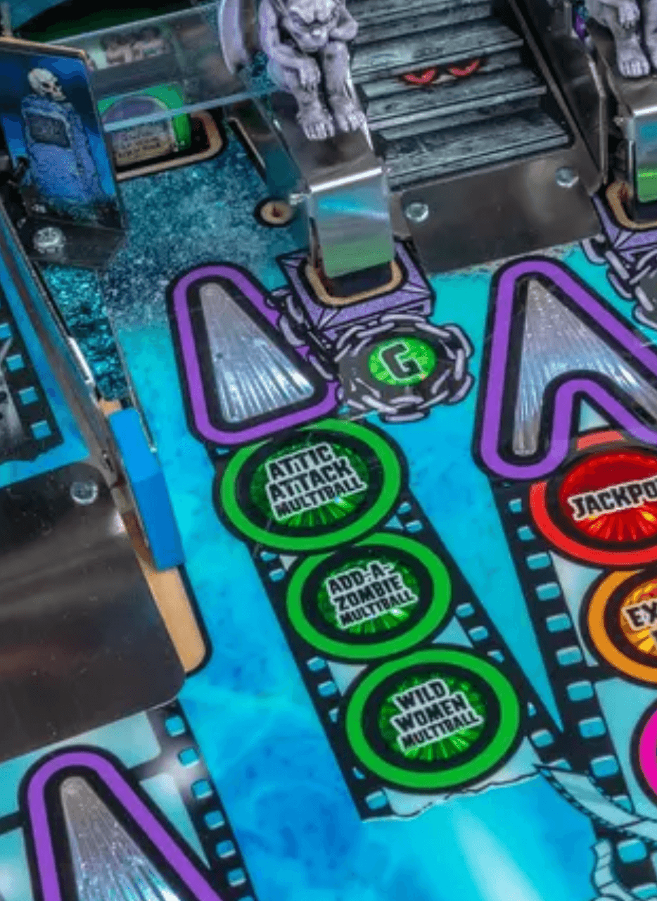 Pinball machine playfield with green multiball targets and gargoyle