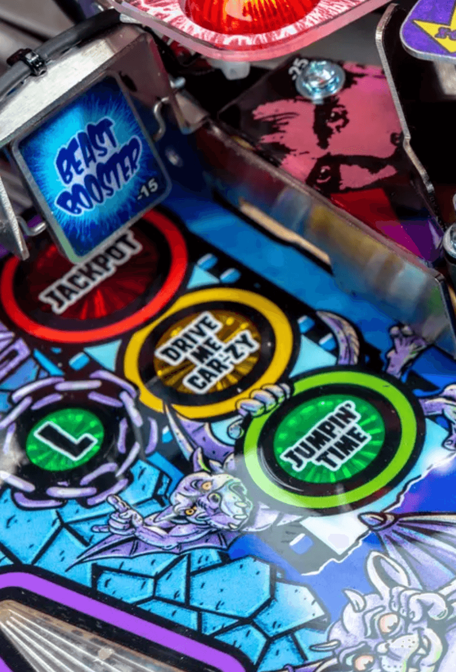 Colorful pinball machine details with game buttons and cartoon characters