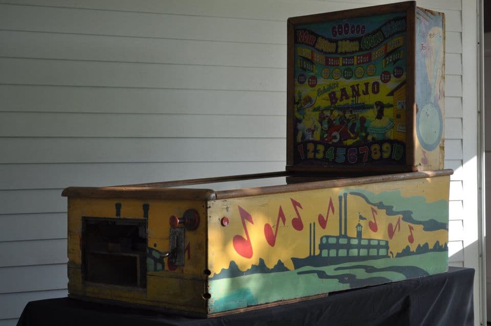 Vintage banjo pinball machine with colorful graphics on wooden cabinet