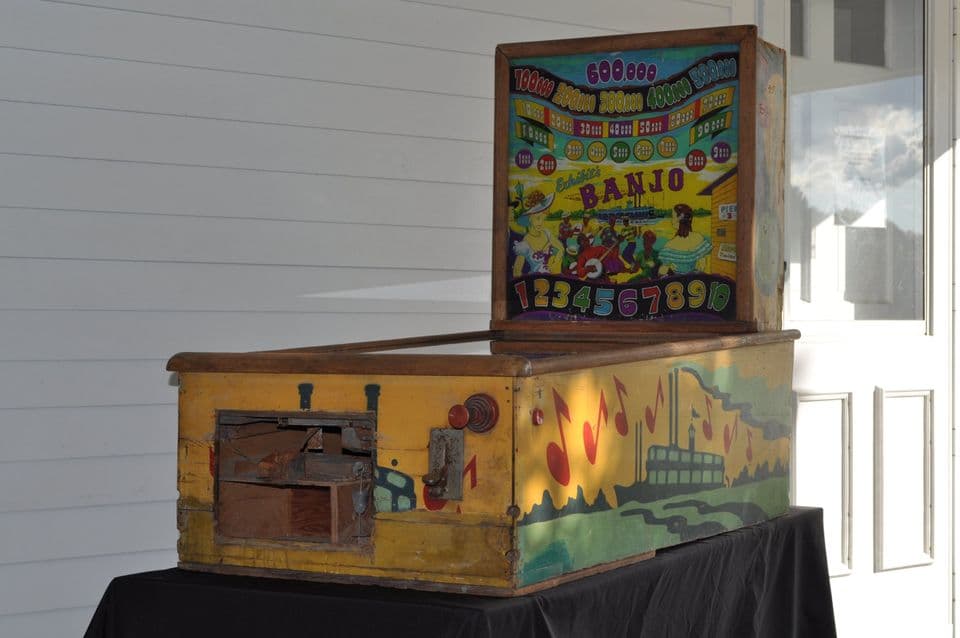 Vintage Banjo pinball machine with colorful artwork on yellow wooden case