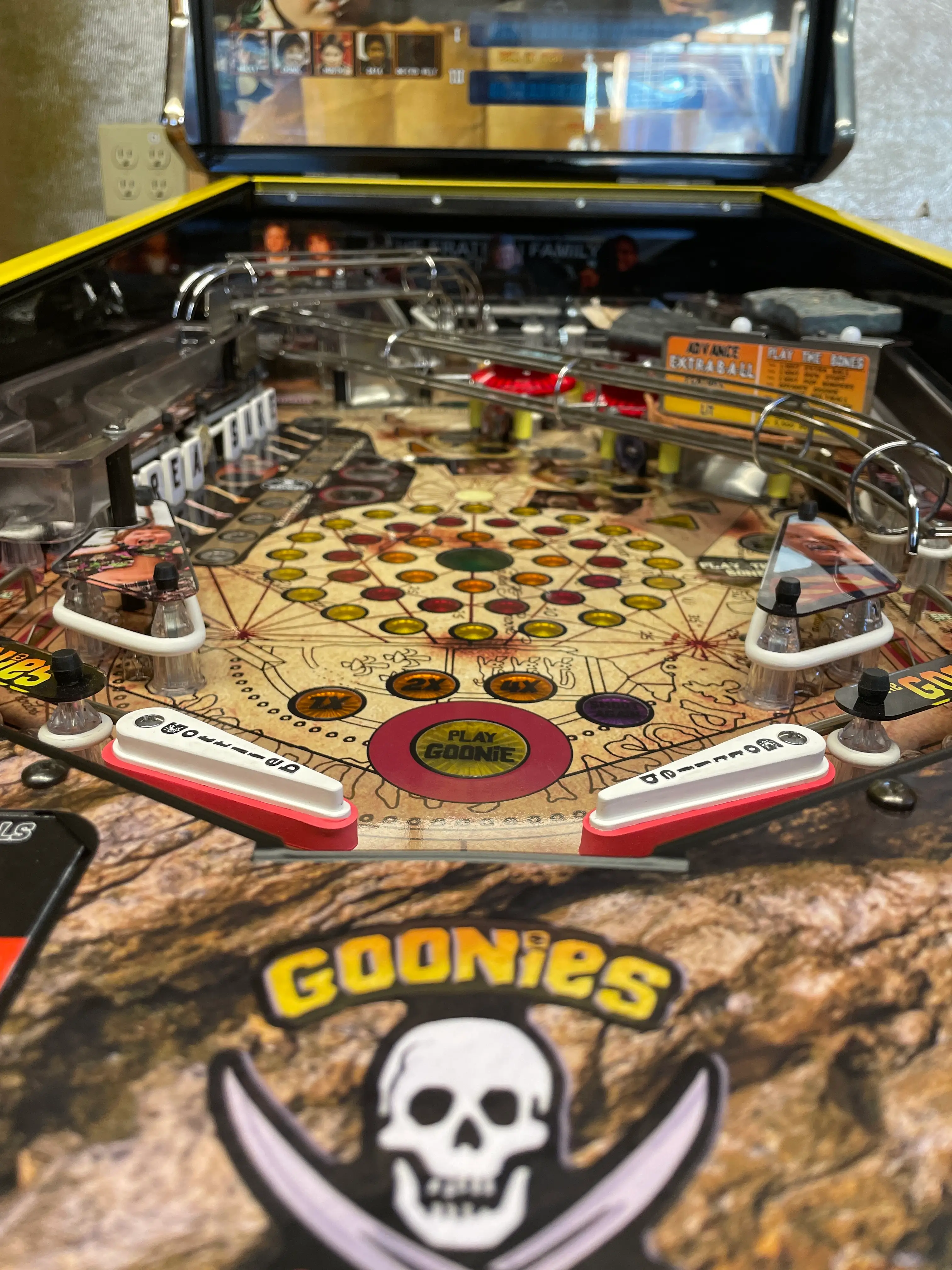 The Goonies pinball machine with colorful playfield and skull logo