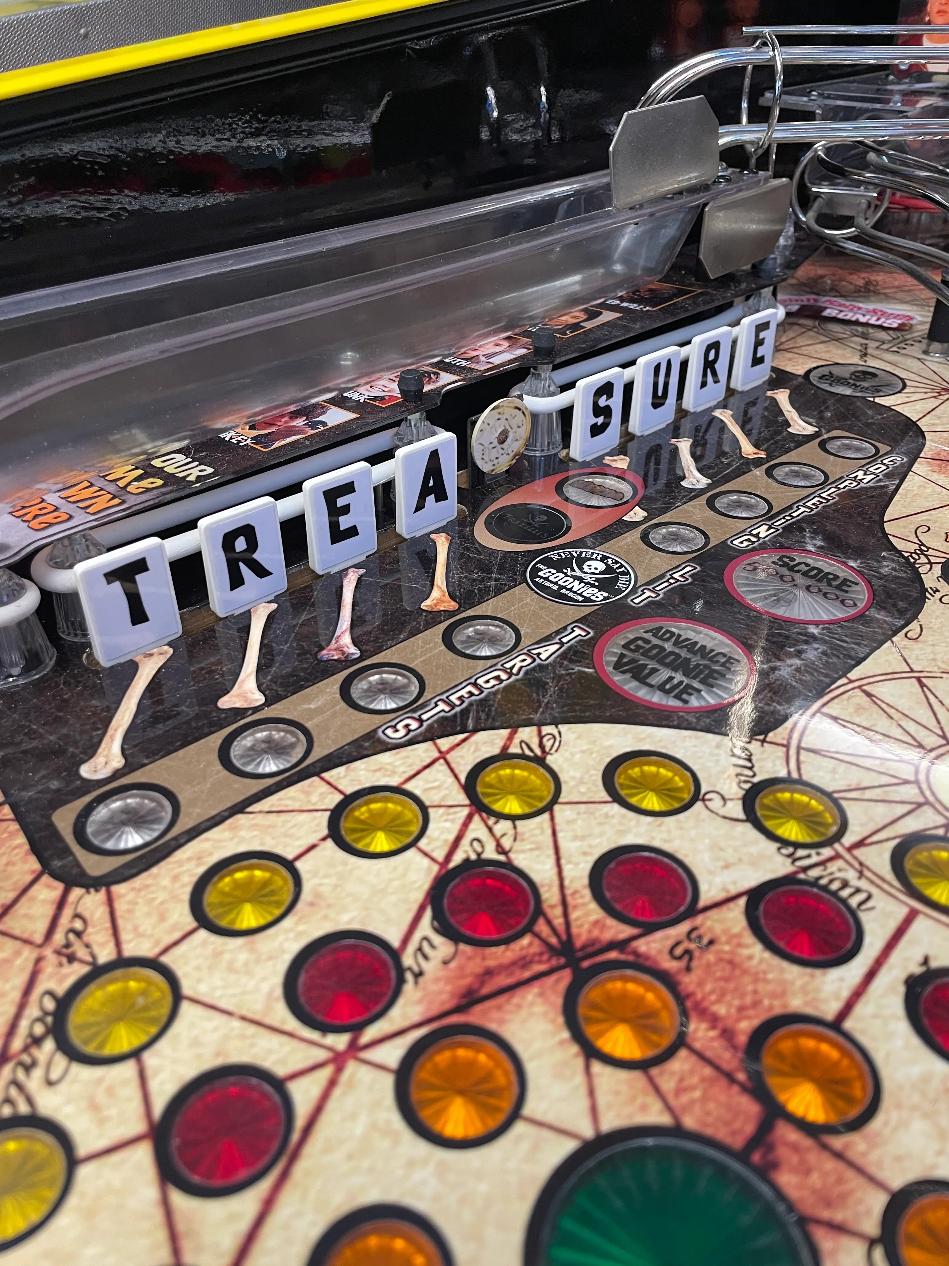 Treasure board game with letter tiles, colored circles, and game pieces