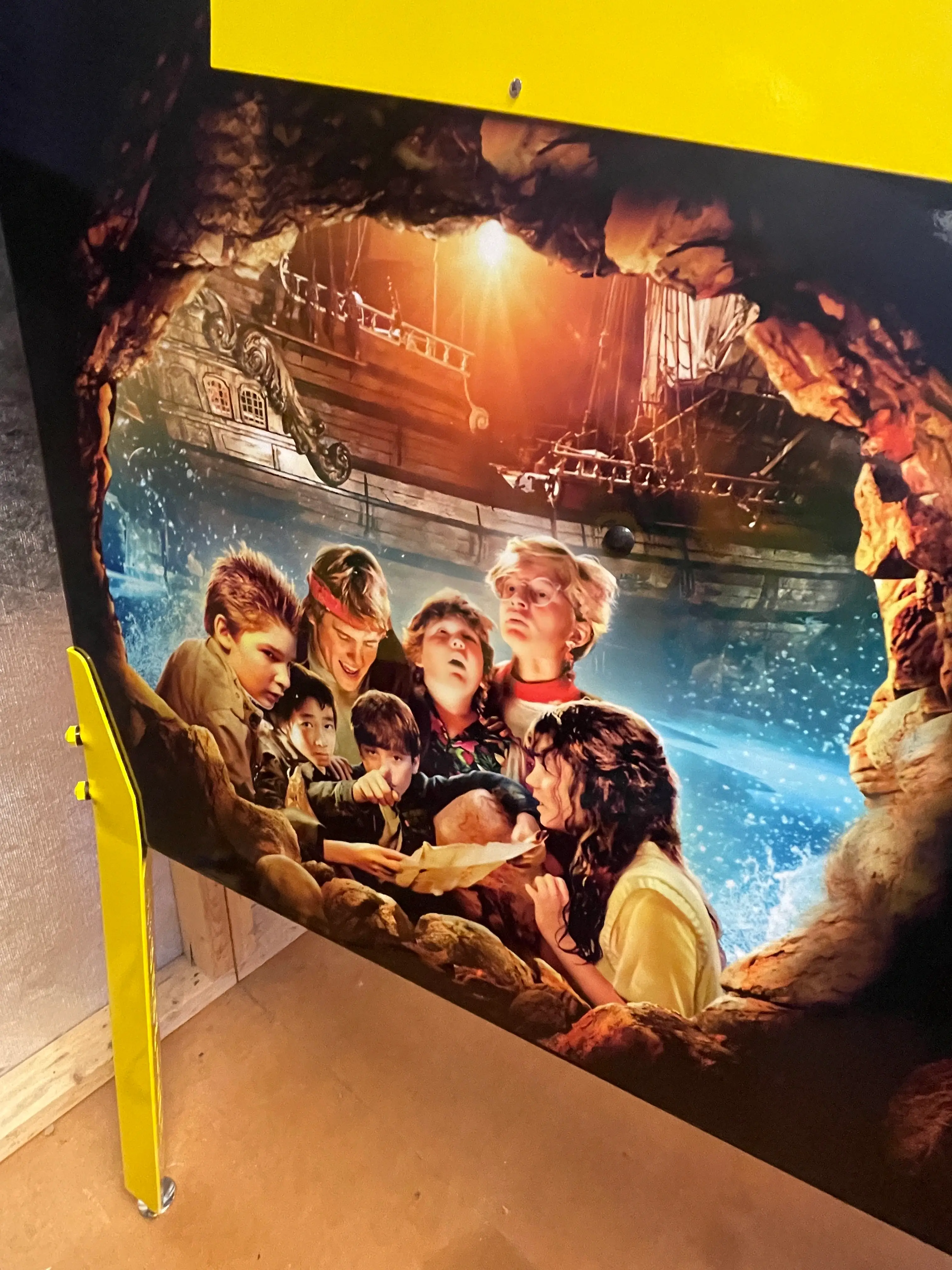 The Goonies movie poster with children on adventure near pirate ship