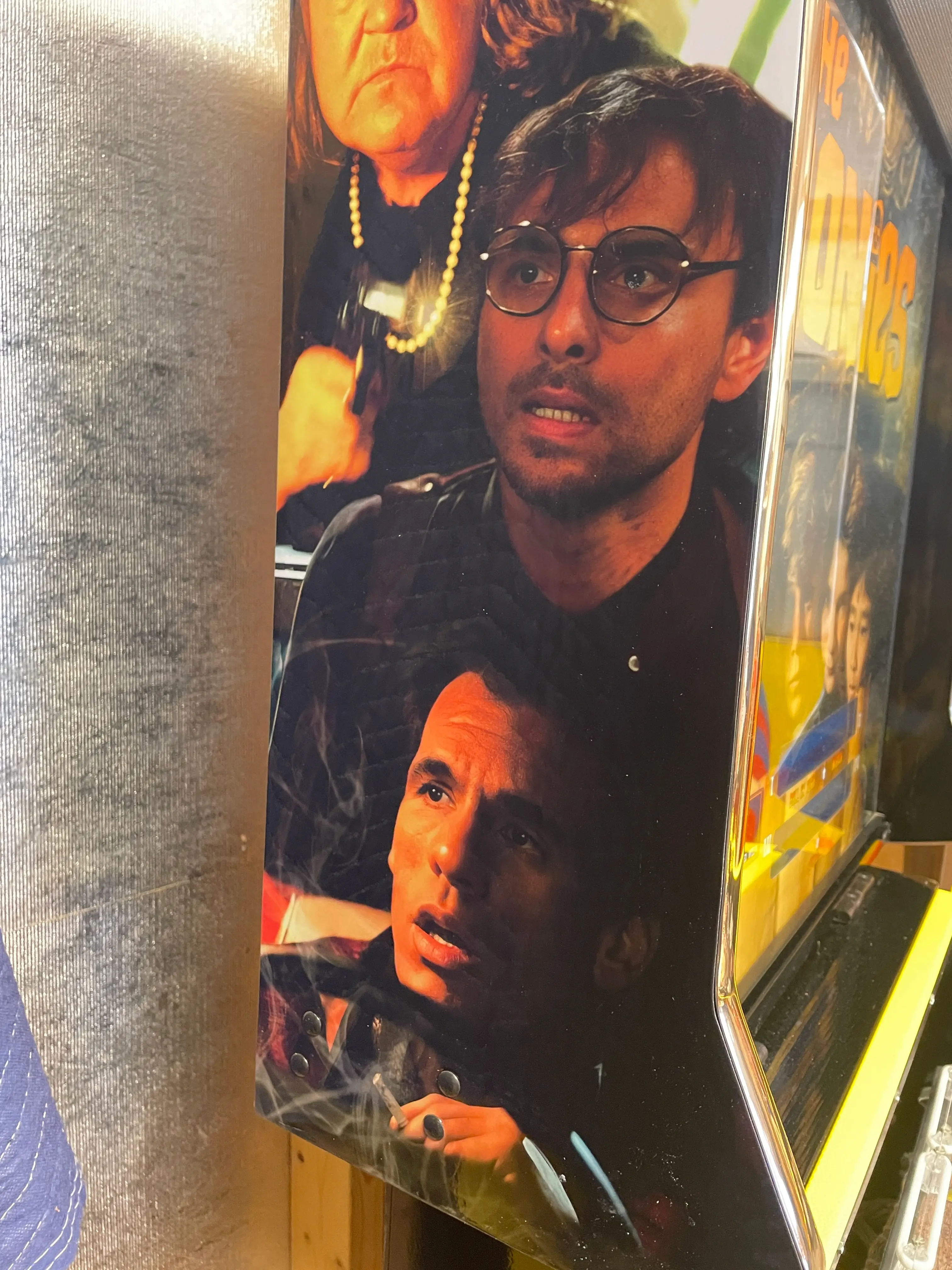 Movie poster with three individuals in dramatic lighting and poses