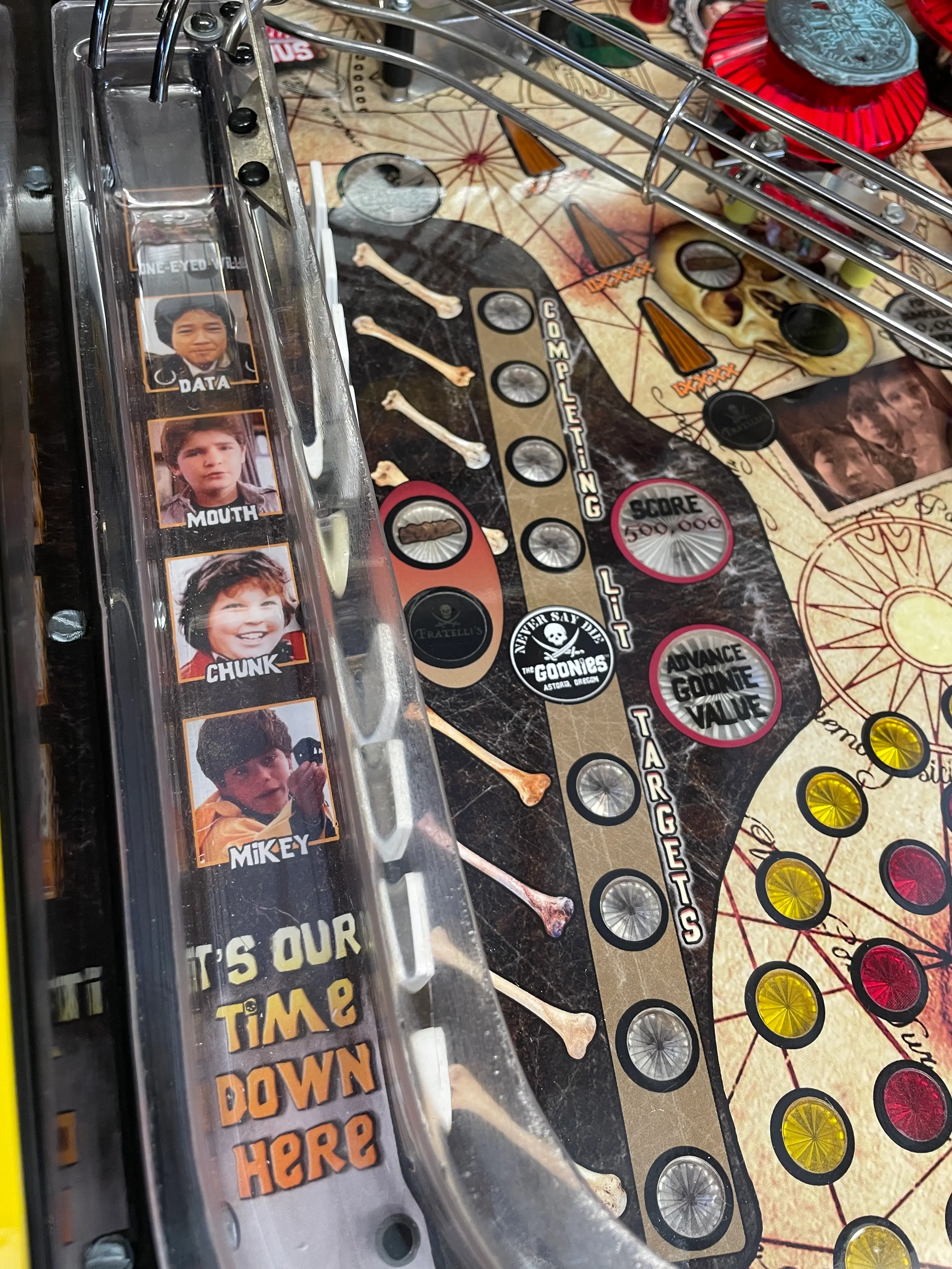 The Goonies pinball machine with character photos and game board details